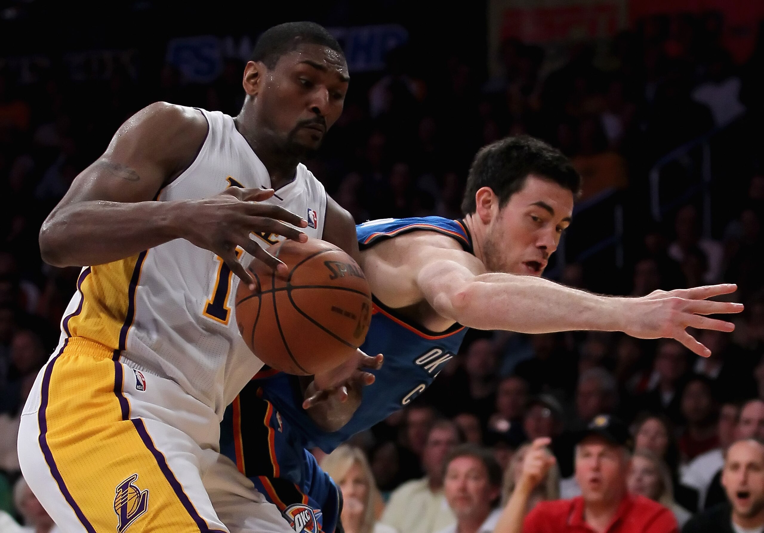 LOS ANGELES, CA - APRIL 10:  Nick Collison #4 of the Oklahoma City Thunder attempts to steal the ball from Ron Artest #15 of the Los Angeles Lakers in the first half at Staples Center on April 10, 2011 in Los Angeles, California. The Thunder defeated the