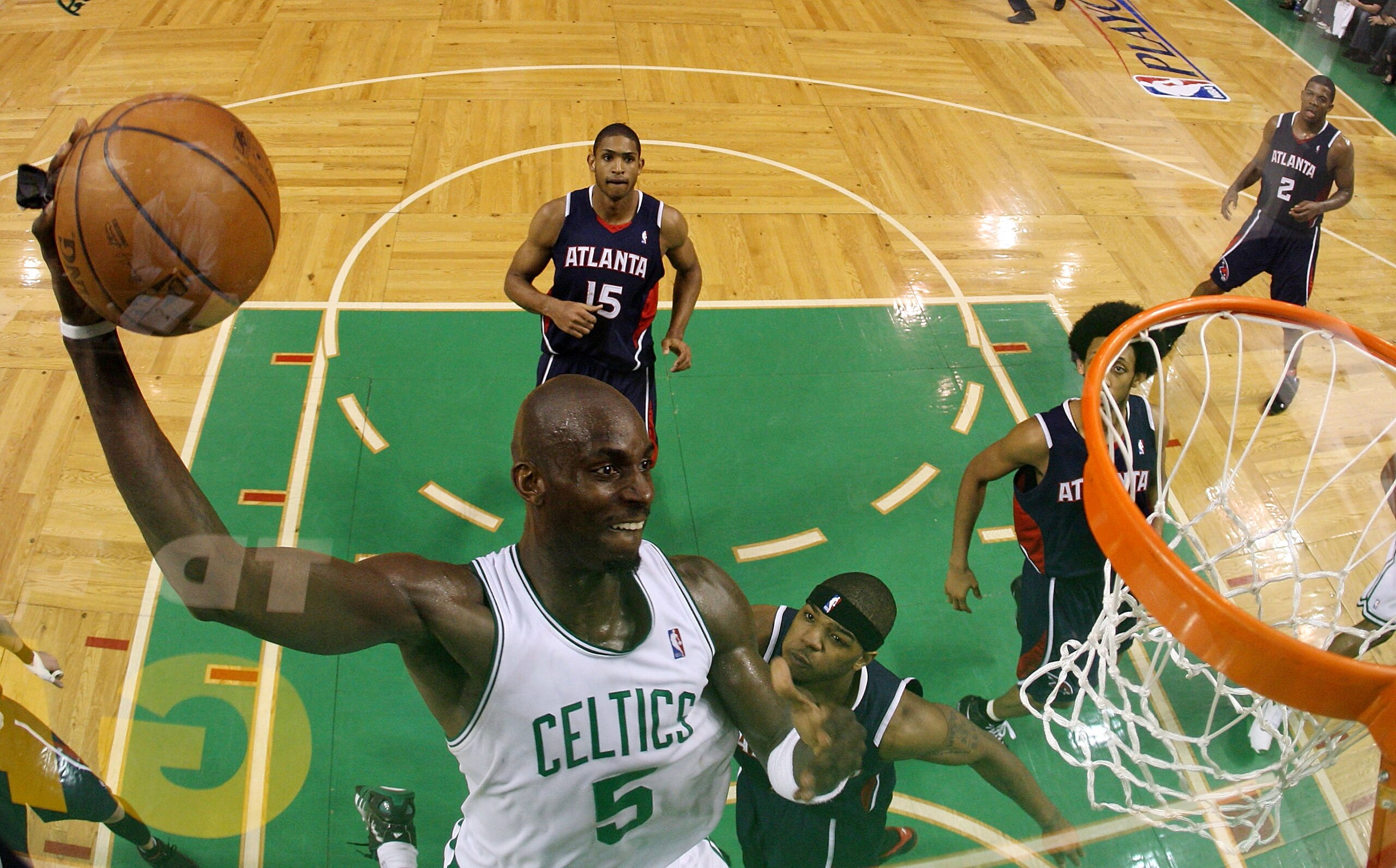 BOSTON - MAY 04:  Kevin Garnett #5 of the Boston Celtics dunks the ball as Josh Smith #5 and Al Horford #15 of the Atlanta Hawks defend during Game Seven of the Eastern Conference Quarterfinals during the 2008 NBA Playoffs on May 4, 2008 at the TD Banknor
