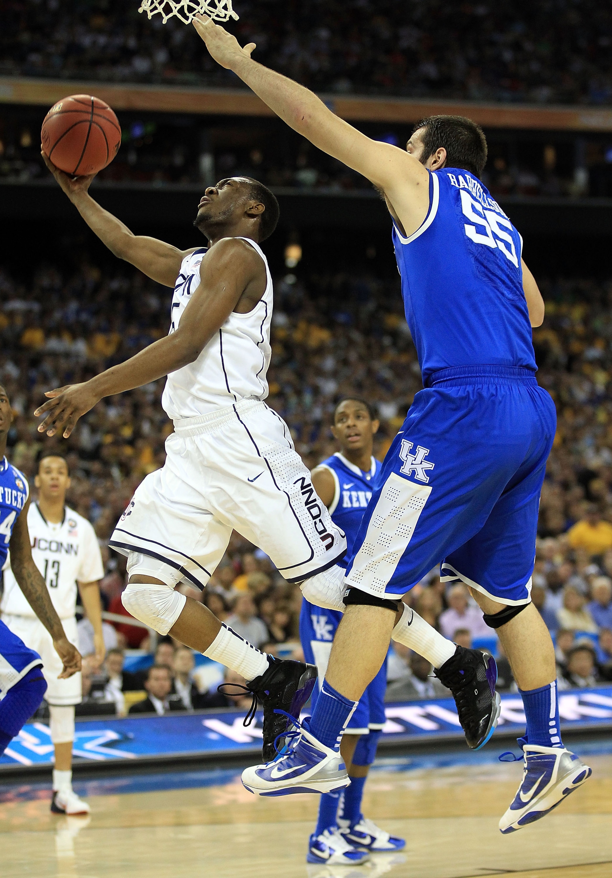 HOUSTON, TX - APRIL 02: Kemba Walker #15 of the Connecticut Huskies goes to the hoop past Josh Harrellson #55 of the Kentucky Wildcats during the National Semifinal game of the 2011 NCAA Division I Men's Basketball Championship at Reliant Stadium on Apri HOUSTON, TX - APRIL 02: Kemba Walker #15 of the Connecticut Huskies goes to the hoop past Josh Harrellson #55 of the Kentucky Wildcats during the National Semifinal game of the 2011 NCAA Division I Men's Basketball Championship at Reliant Stadium on Apri