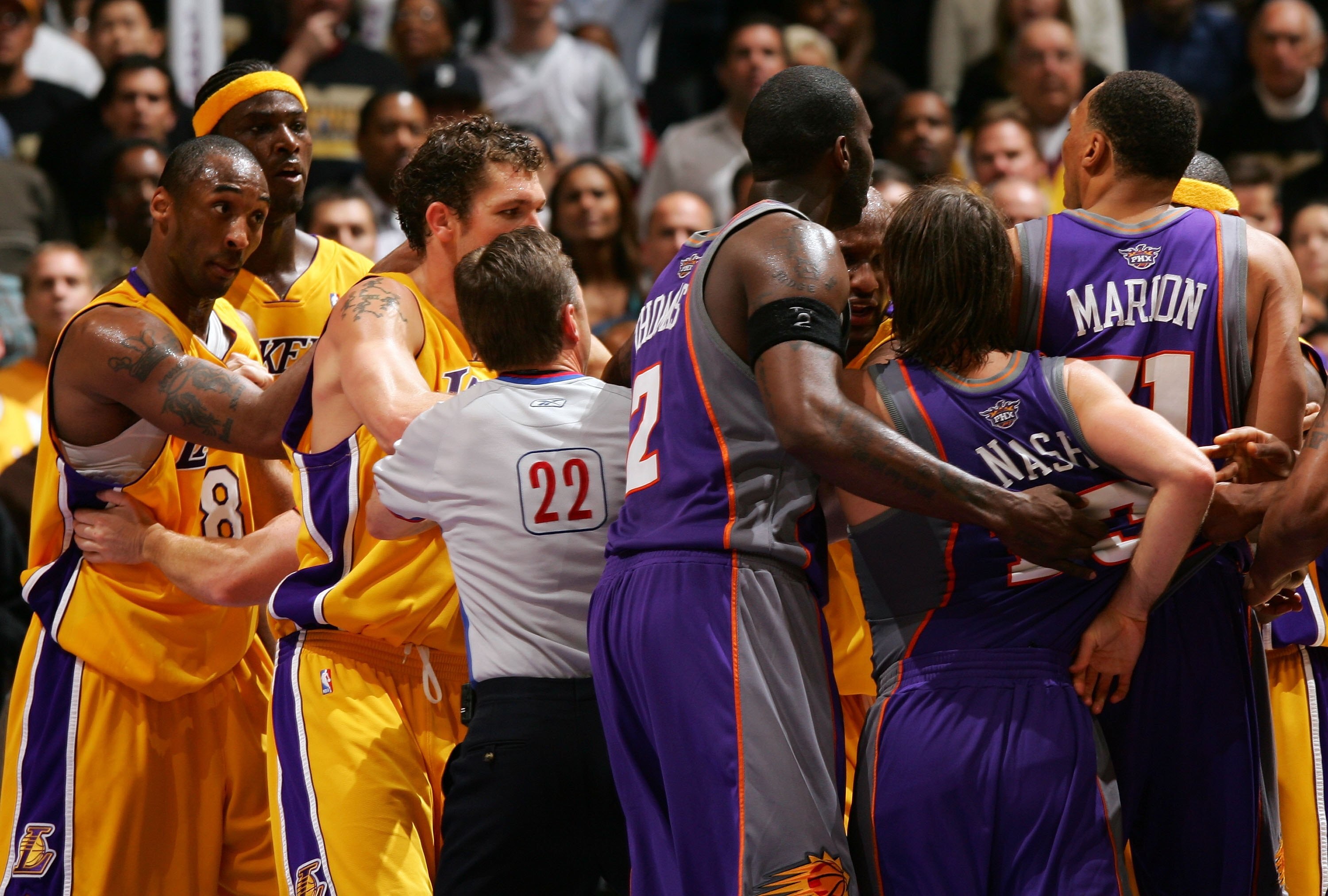 LOS ANGELES, CA - APRIL 28:  Kobe Bryant #8  (L) of the Los Angeles Lakers looks and points at players from the Phoenix Suns, including Shawn Marion (R) #31 as referee Bill Spooner #22 tries to seperate the players from both teams, after some physical pla