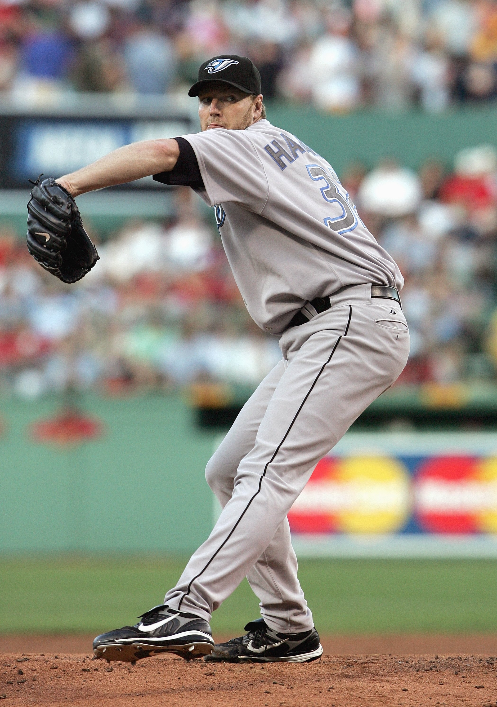BOSTON - JULY 12: Roy Halladay #32 of the Toronto Blue Jays delivers a pitch in the first inning against the Boston Red Sox at Fenway Park July 12, 2007 in Boston, Massachusetts. (Photo by Elsa/Getty Images)