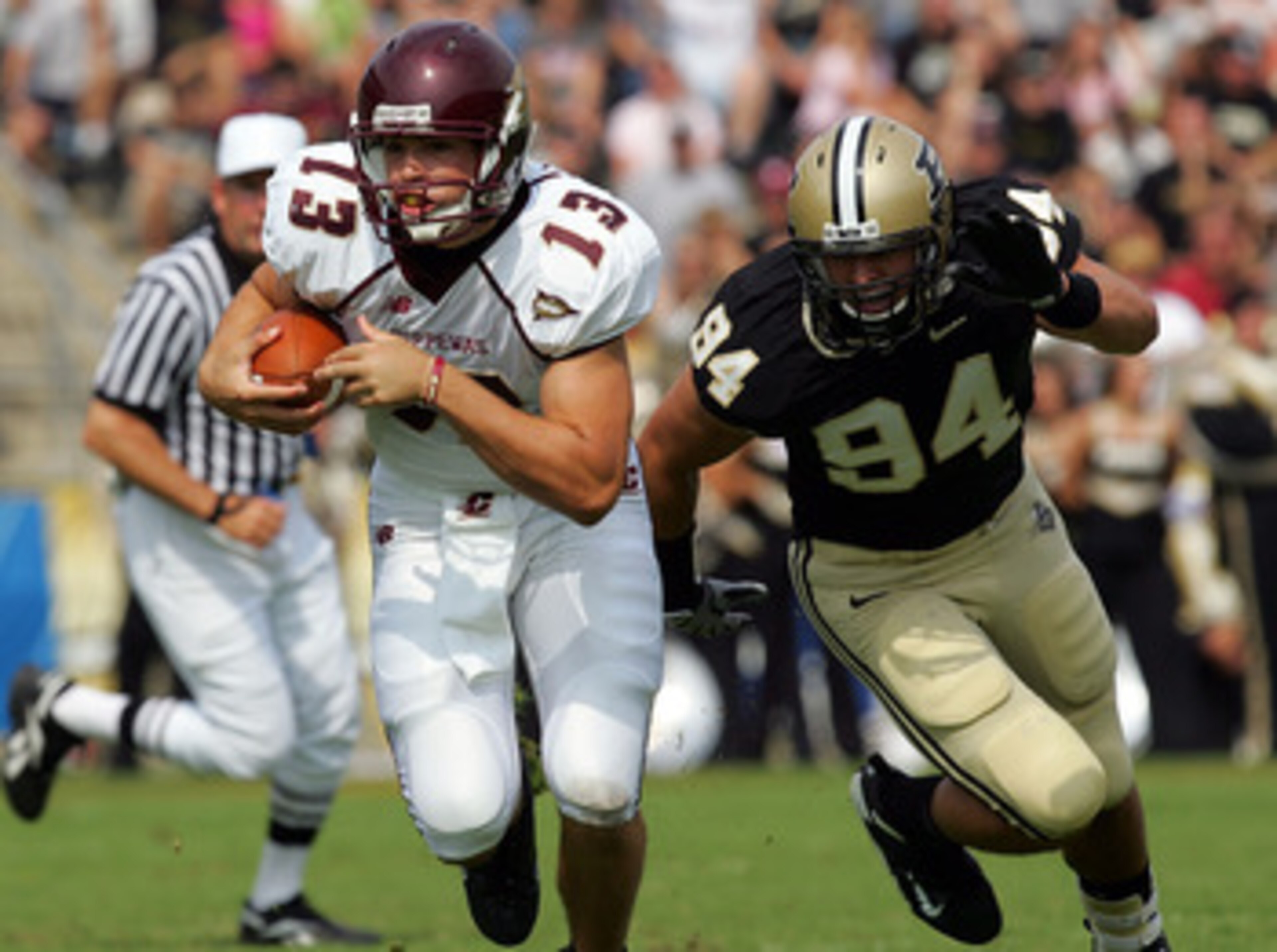 WEST LAFAYETTE, IN - SEPTEMBER 20:  Quarterback Dan LeFevour #13 of the Central Michigan Chippewas runs the ball past Ryan Kerrigan #94 of the Purdue Boilermakers at Ross-Ade Stadium on September 20, 2008 in West Lafayette, Indiana.  (Photo by Ronald Mart