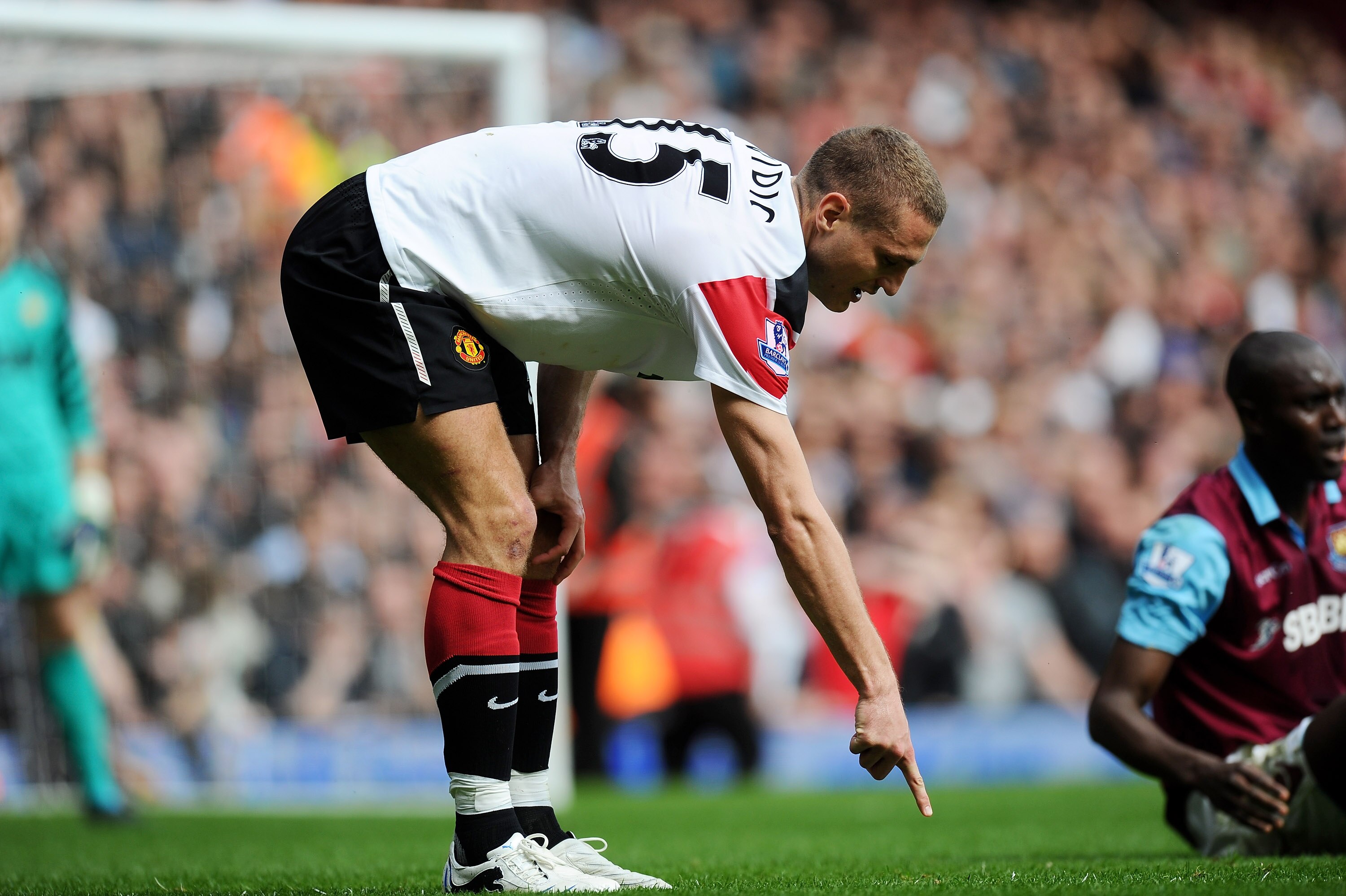 LONDON, ENGLAND - APRIL 02: Nemanja Vidic of Manchester United points to the spot where he believed he challenged Carlton Cole of West Ham United after a second penalty was awarded to West Ham United during the Barclays Premier League match between West H