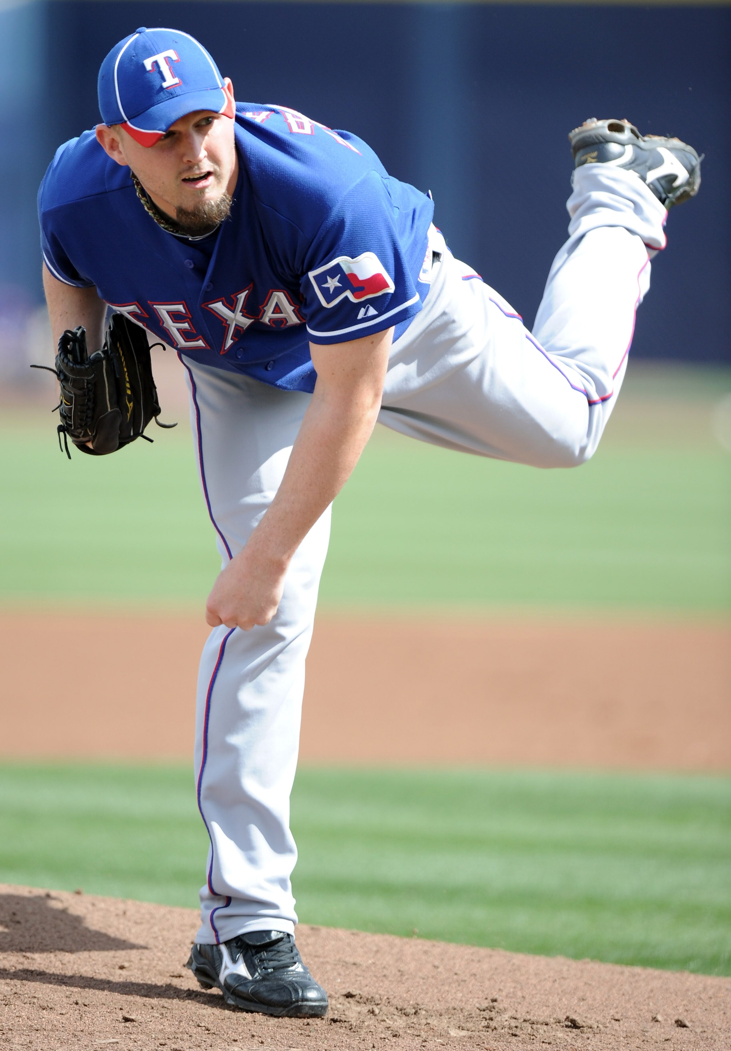 PEORIA, AZ - MARCH 01:  Matt Harrison #54 of the Texas Rangers pitches against the Seattle Mariners in the first inning during spring training at Peoria Stadium on March 1, 2011 in Peoria, Arizona.  (Photo by Harry How/Getty Images)