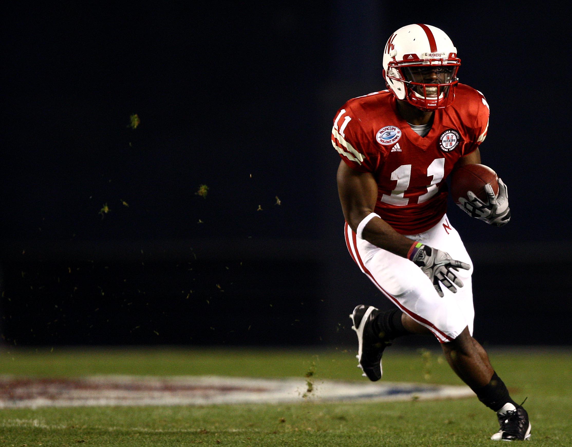 SAN DIEGO, CA - DECEMBER 30:  Wide receiver Curenski Gilleylen #11 of the University of Nebraska Cornhuskers runs the ball against the against the University of Arizona Wildcats during the Pacific Life Holiday Bowl,  on December 30, 2009 at Qualcomm Stadi