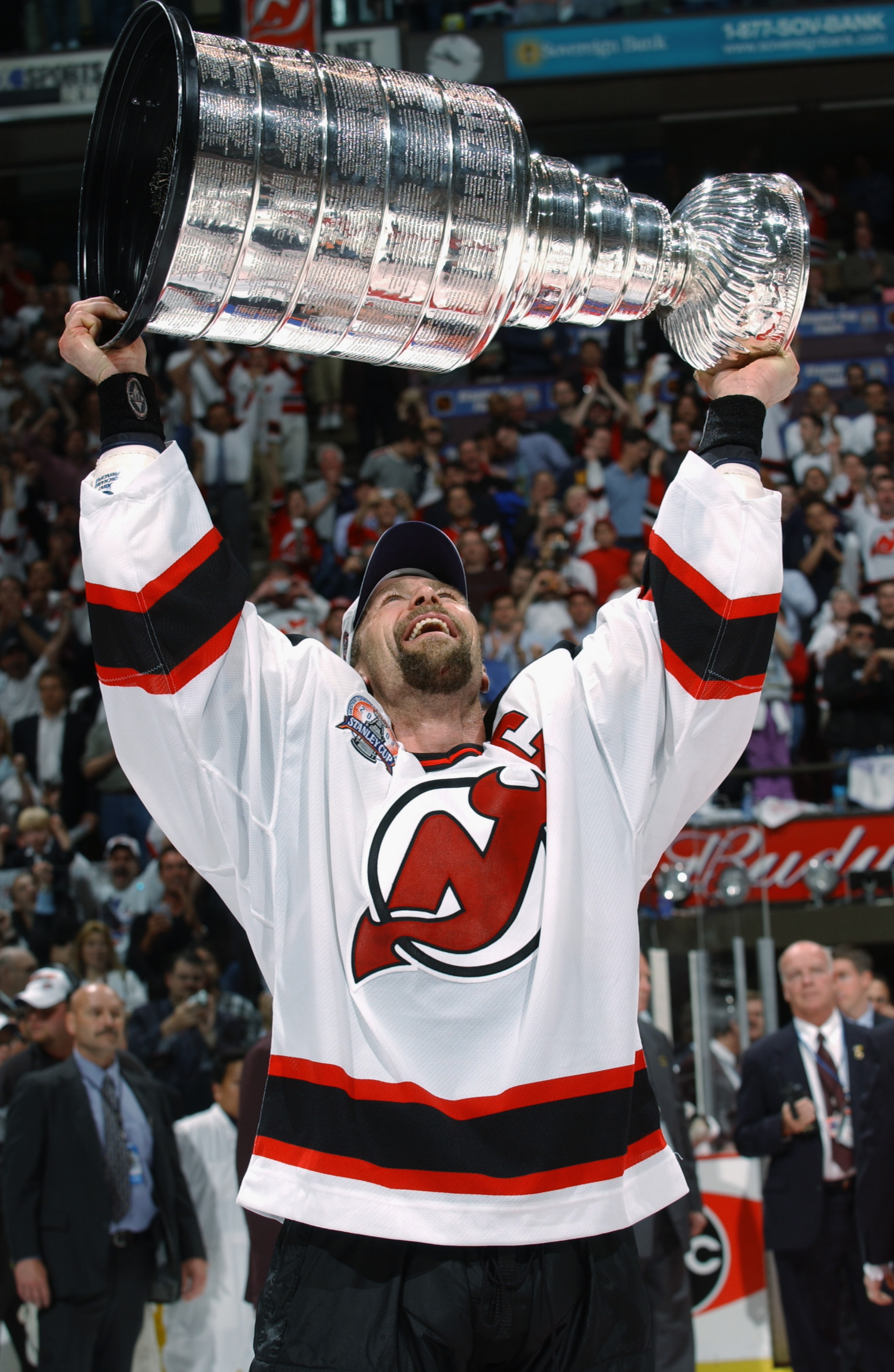 EAST RUTHERFORD, NJ - JUNE 9:  Scott Stevens of the New Jersey Devils holds up the Stanley Cup after beating the Mighty Ducks of Anaheim in game seven of the 2003 Stanley Cup Finals at Continental Airlines Arena on June 9, 2003 in East Rutherford, New Jer