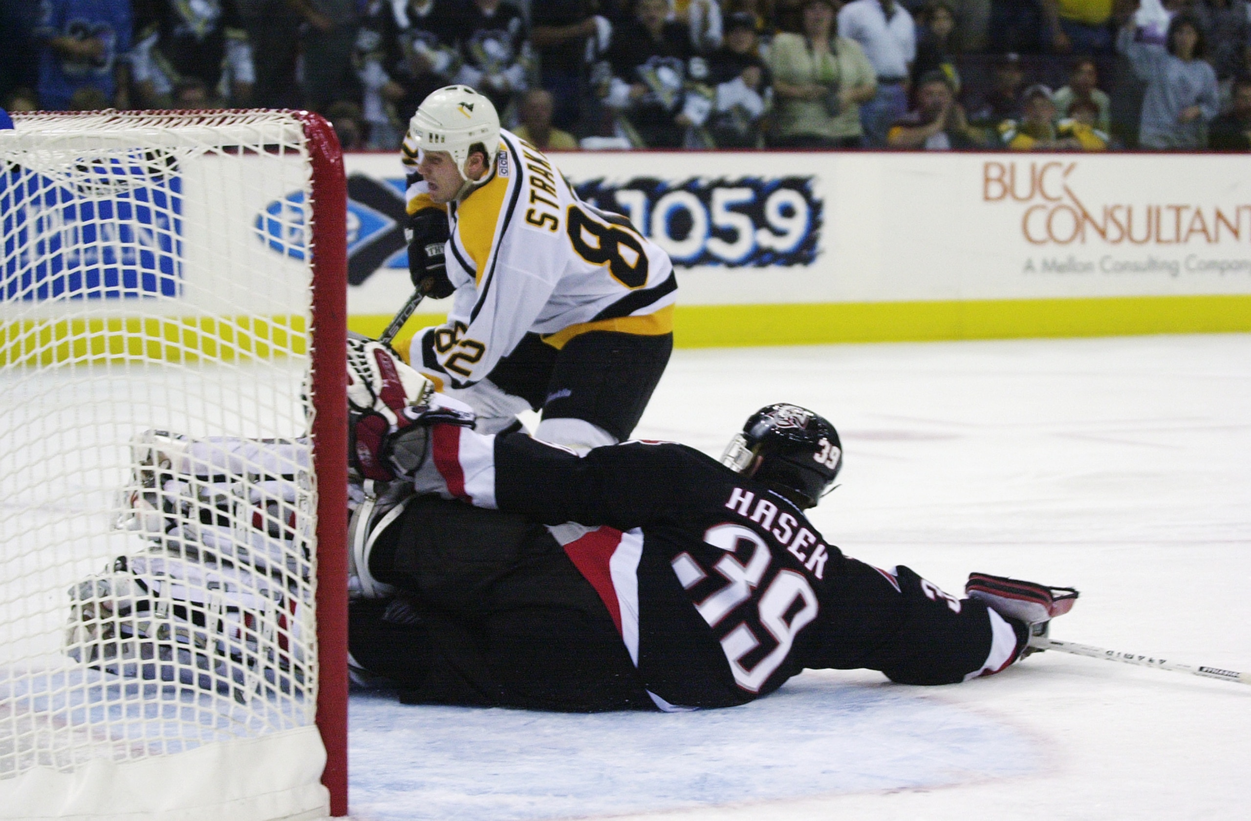 PITTSBURGH - MAY 2:  Martin Straka #82 of the Pittsburgh Penguins skates around goaltender Dominik Hasek #39 of the Buffalo Sabres in Game four of the Eastern Conference Semifinals during the 2001 Stanley Cup playoffs on May 2, 2002 at Mellon Arena in Pit