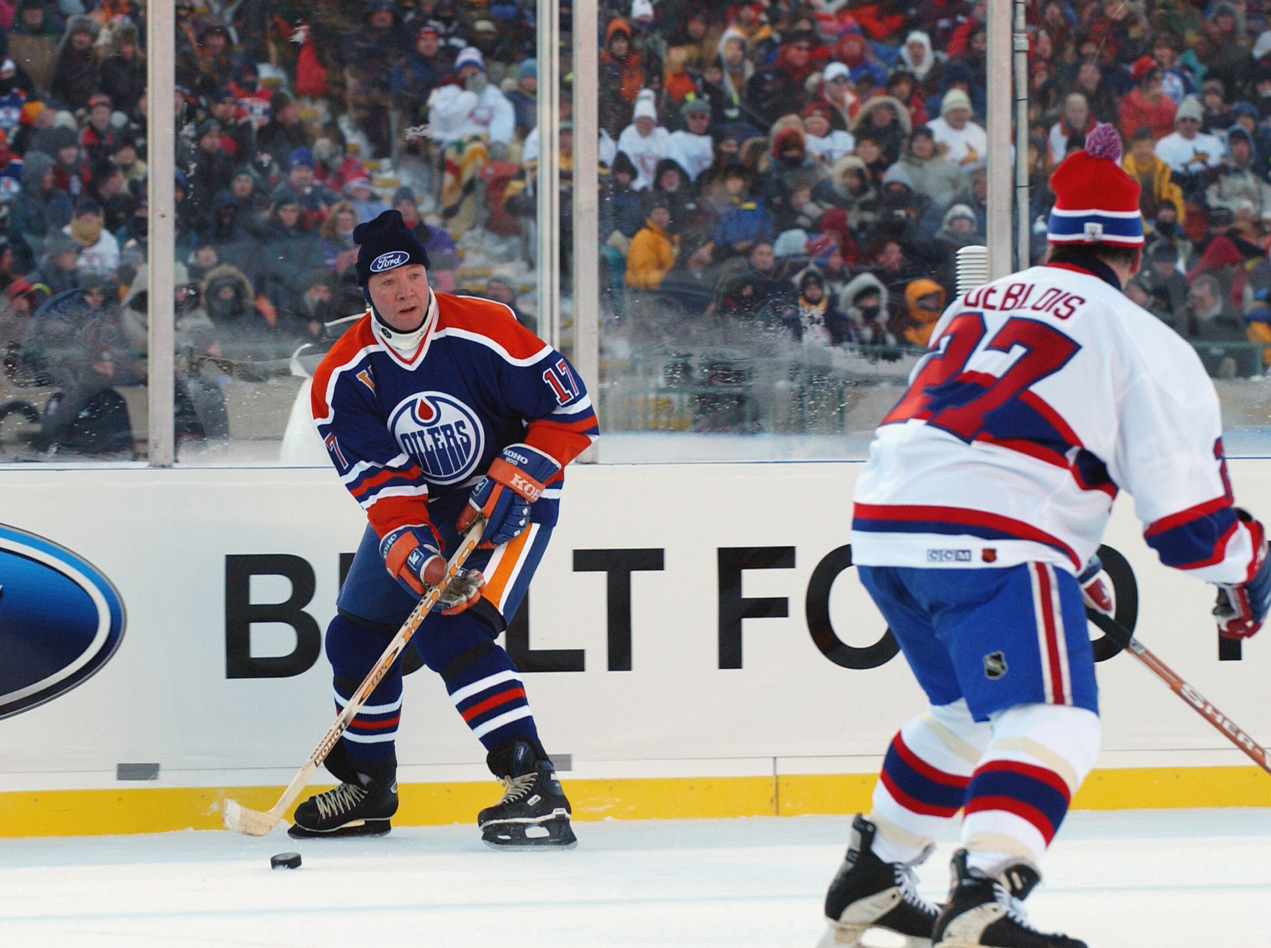 EDMONTON, CANADA - NOVEMBER 22:  Jari Kurri #17 of the Edmonton Oilers looks to make a play against Lucen Deblois #27 of the Montreal Canadiens during the Molson Canadien Heritage Classic on November 22, 2003 at Commonwealth Stadium in Edmonton, Canada. T