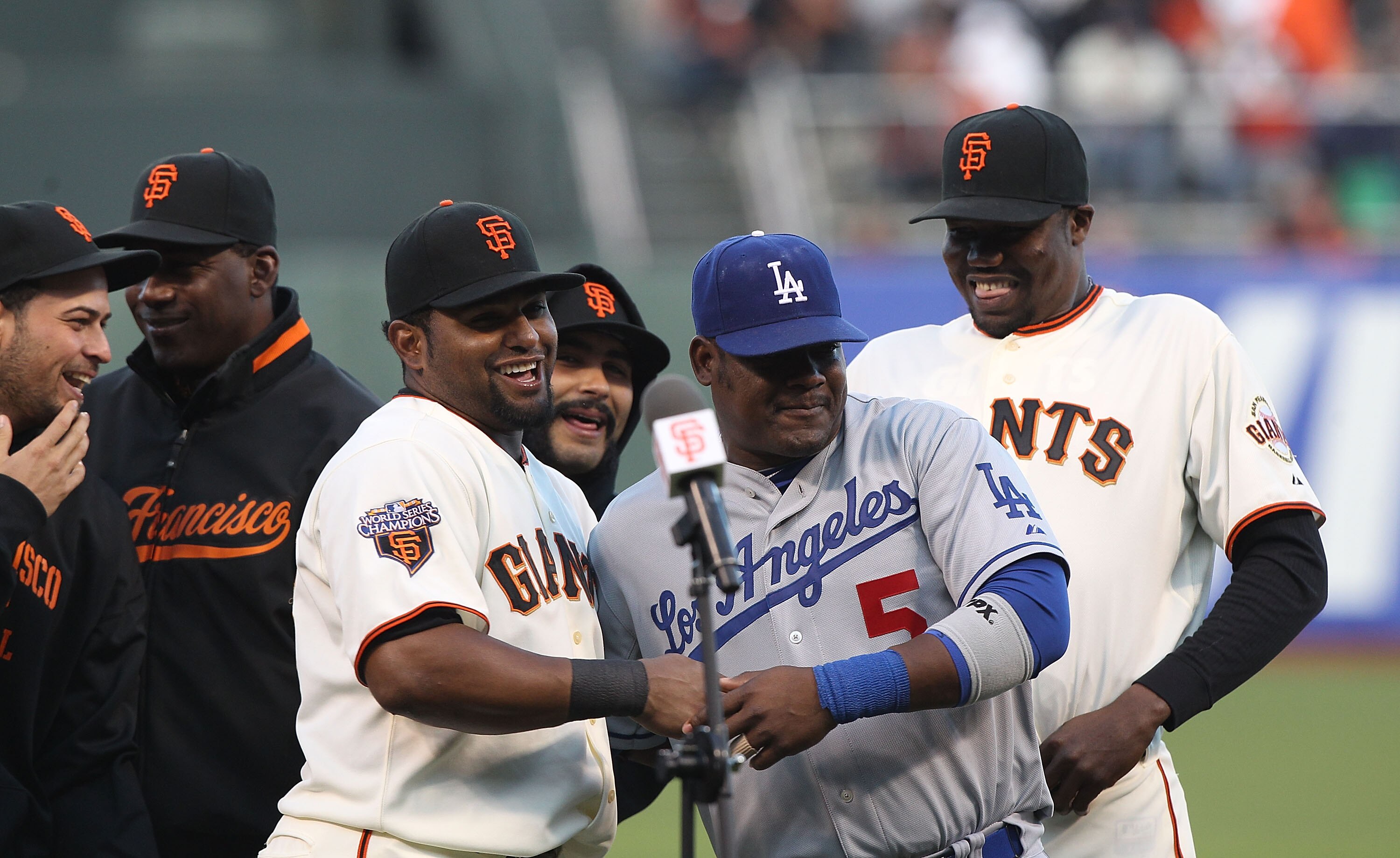 SAN FRANCISCO, CA - APRIL 11:  Juan Uribe #5 of the Los Angeles Dodgers jokes with former teammate Pablo Sandoval #48 after recieving his 2010 World Series ring before his game against the San Francisco Giants during an MLB game at AT&T Park on April 11,