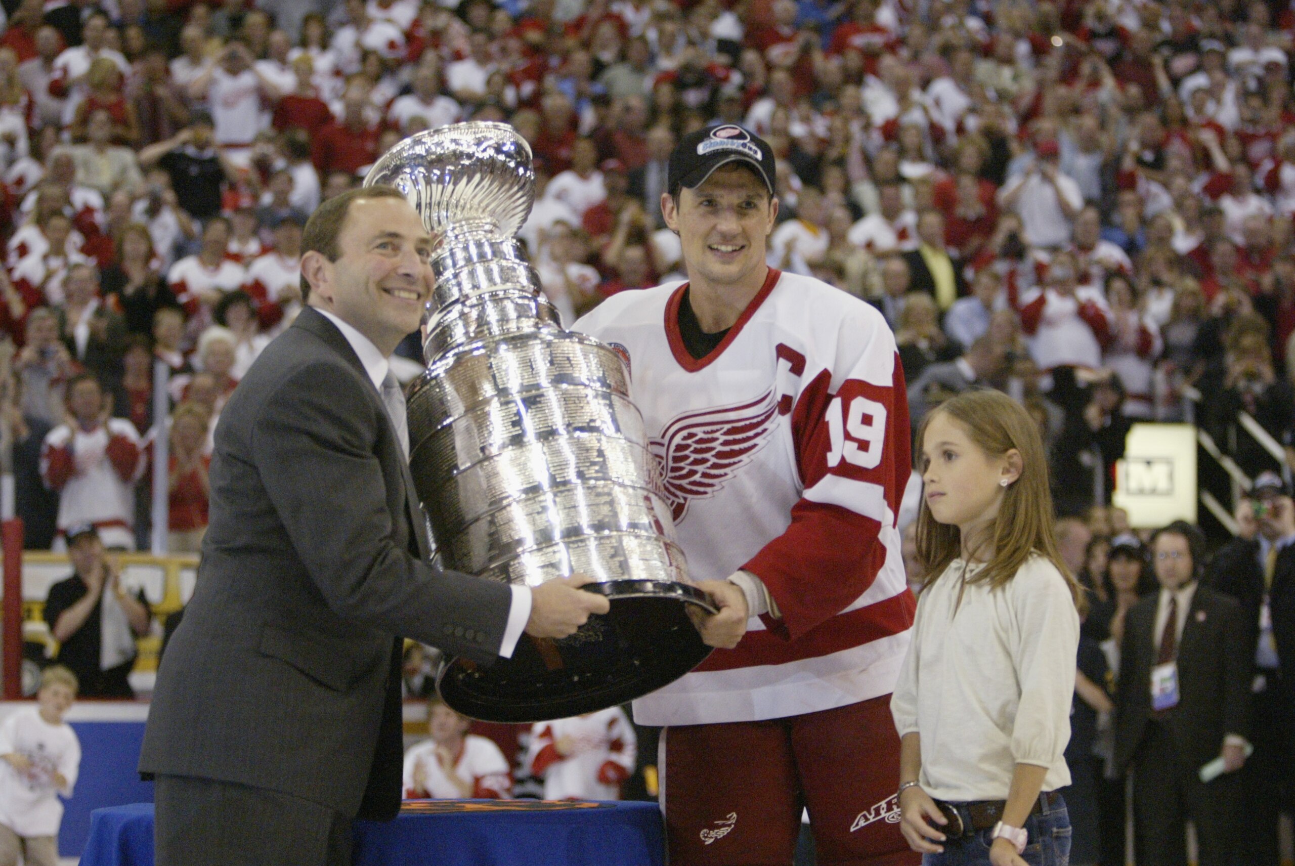 DETROIT, MI - JUNE 13:  Commisioner Gary Bettman presents the Stanley Cup to captain Steve Yzerman of the Detroit Red Wings with his daughter Isabella after eliminating the Carolina Hurricanes during game five of the NHL Stanley Cup Finals on June 13, 200
