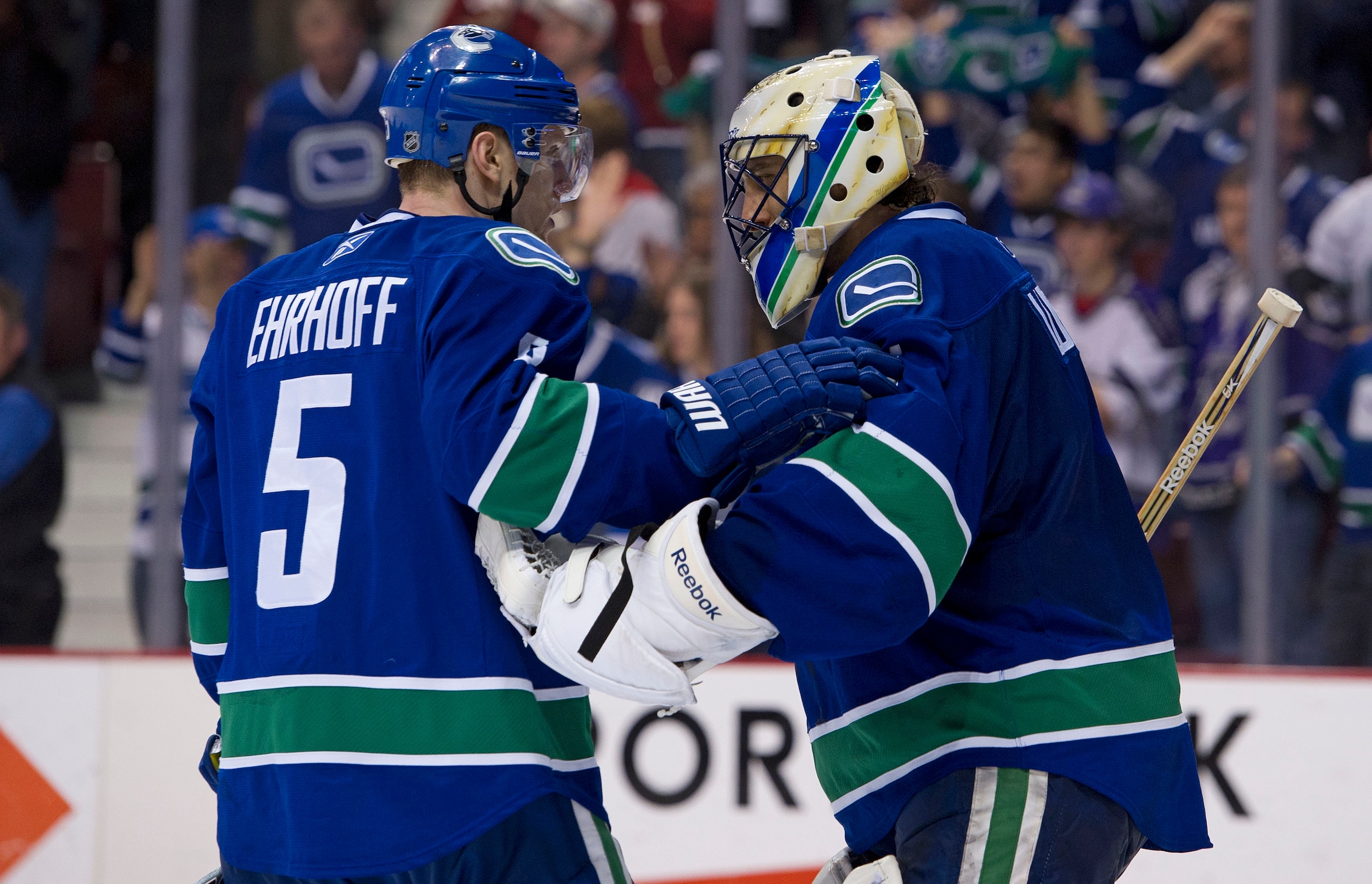 VANCOUVER, CANADA - MARCH 31: Goalie Roberto Luongo #1 of the Vancouver Canucks is congratulated by Christian Ehrhoff #5 after defeating the Los Angeles Kings in NHL action on March 31, 2011 at Rogers Arena in Vancouver, BC, Canada.  (Photo by Rich Lam/Ge