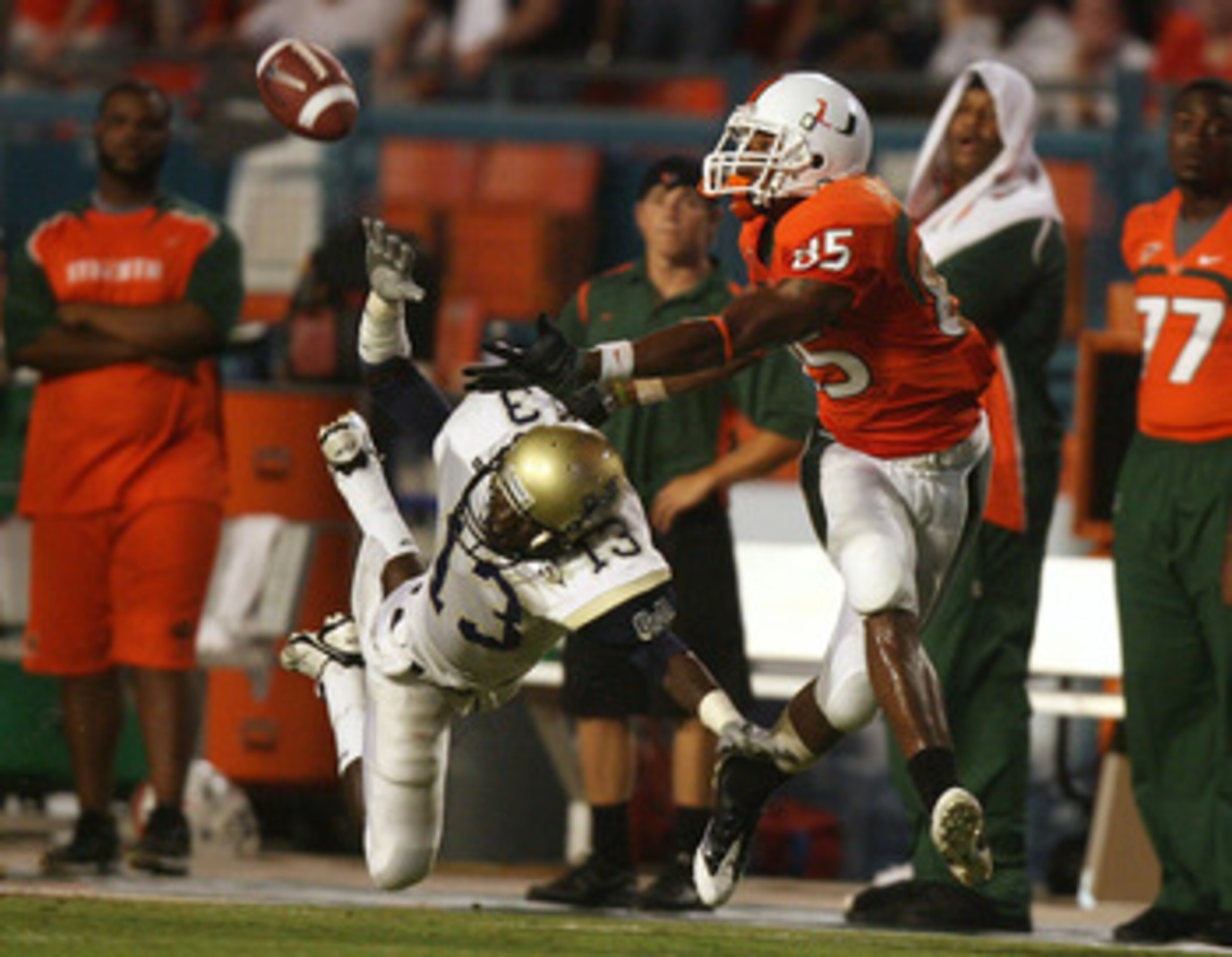 MIAMI - AUGUST 28:  Defensive back Jacques Bazile #13 of the Charleston Southern Buccaneers dives to try and knock down a pass intended for wide receiver Leonard Hankerson #85 of the Miami Hurricanes at Dolphin Stadium on August 28, 2008 in Miami, Florida
