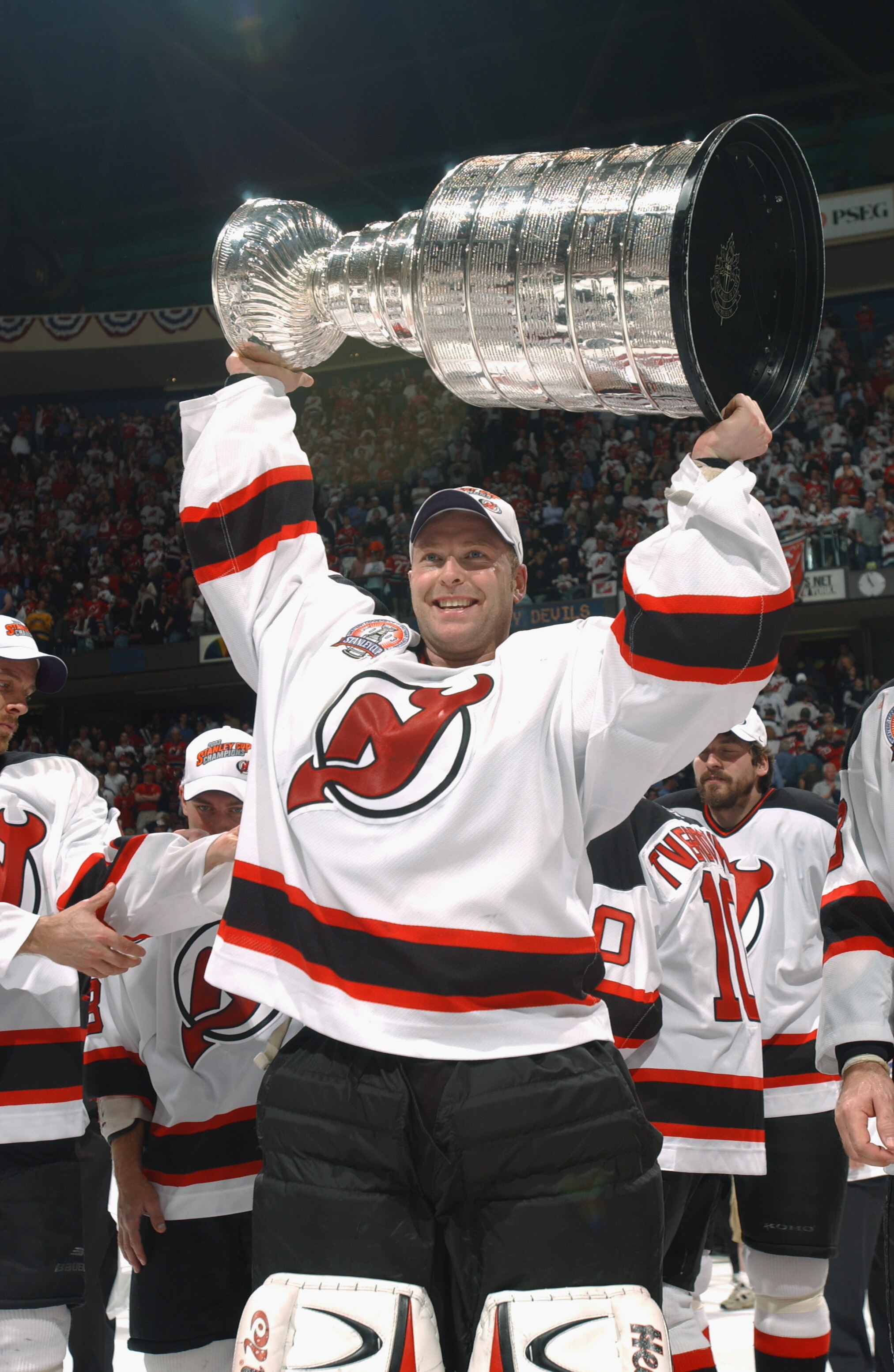 EAST RUTHERFORD, NJ - JUNE 9:  Martin Brodeur #30 of the New Jersey Devils raises the Stanley Cup after defeating the Mighty Ducks of Anaheim in game seven of the 2003 Stanley Cup Finals at Continental Airlines Arena on June 9, 2003 in East Rutherford, Ne