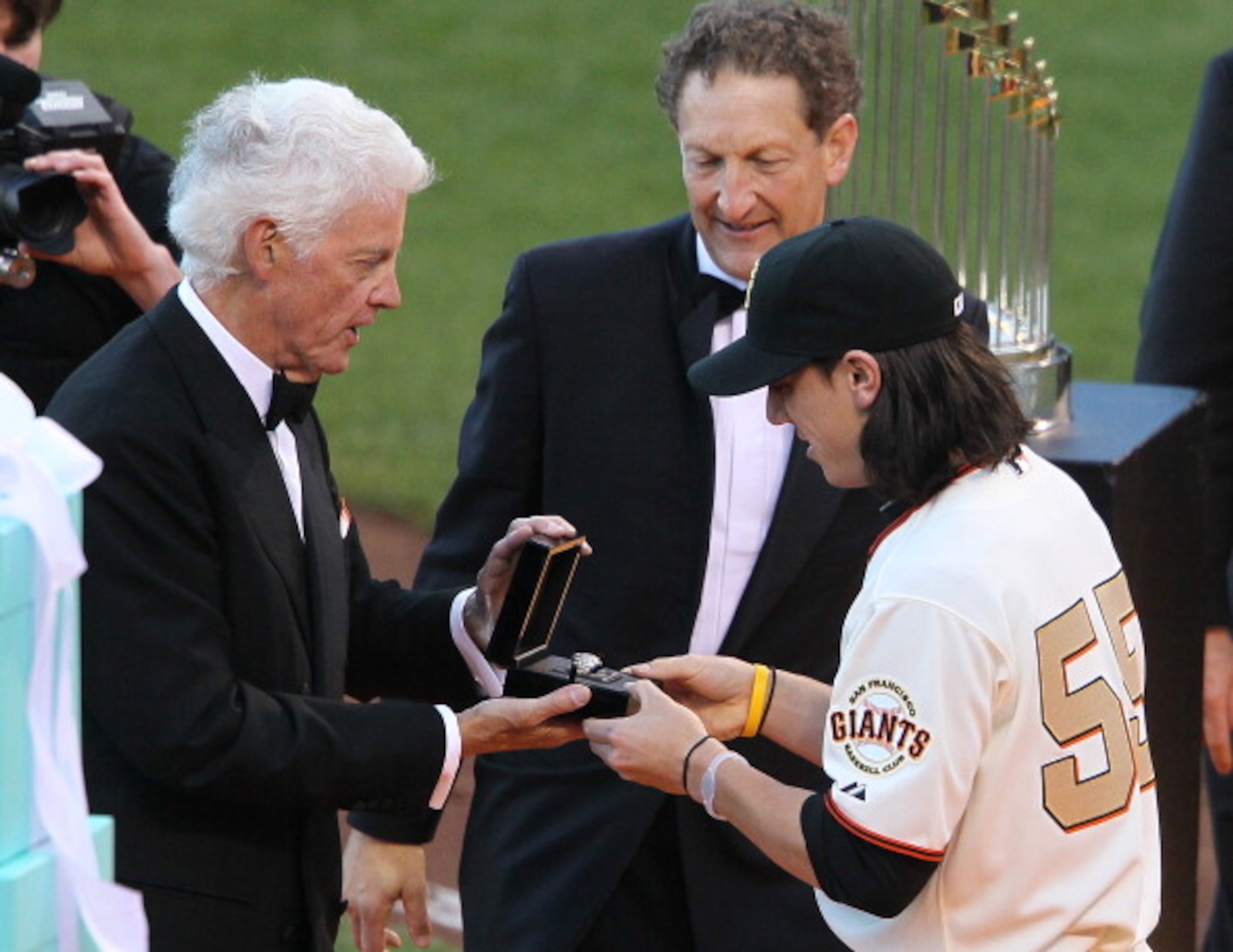 SAN FRANCISCO, CA - APRIL 09:  Tim Lincecum #55 of the San Francisco Giants receives his World Series ring from Giants owner Bill Neukom (L) and Giants President Larry Baer before the start of the game against the St. Louis Cardinals at AT&T Park on April