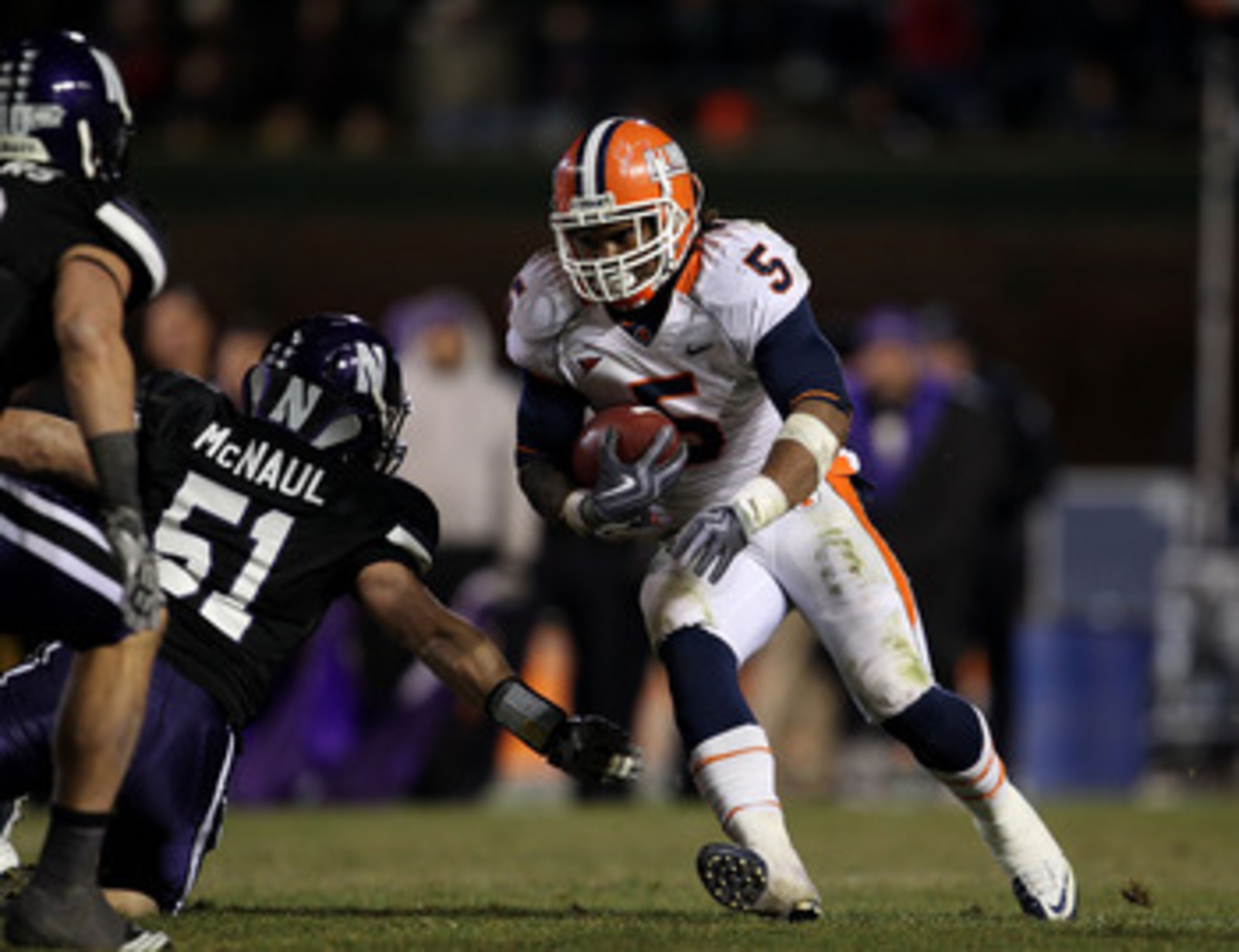 CHICAGO - NOVEMBER 20: Mikel Leshoure #5 of the Illinois Fighting Illini runs past Bryce McNaul #51 of the Northwestern Wildcats on his way to a 339 yard rushing performance during a game played at Wrigley Field on November 20, 2010 in Chicago, Illinois. CHICAGO - NOVEMBER 20: Mikel Leshoure #5 of the Illinois Fighting Illini runs past Bryce McNaul #51 of the Northwestern Wildcats on his way to a 339 yard rushing performance during a game played at Wrigley Field on November 20, 2010 in Chicago, Illinois.
