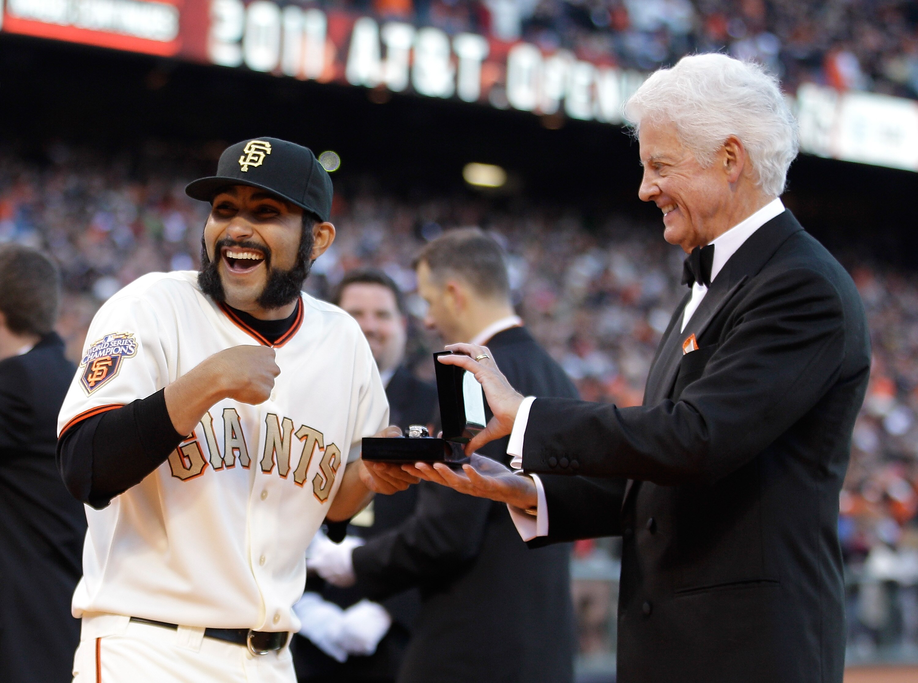 SAN FRANCISCO, CA - APRIL 09:  Sergio Romo #54 of the San Francisco Giants reacts as he receives his World Series ring from Giants owner Bill Neukom  before the start of the game against the St. Louis Cardinals at AT&T Park on April 9, 2011 in San Francis