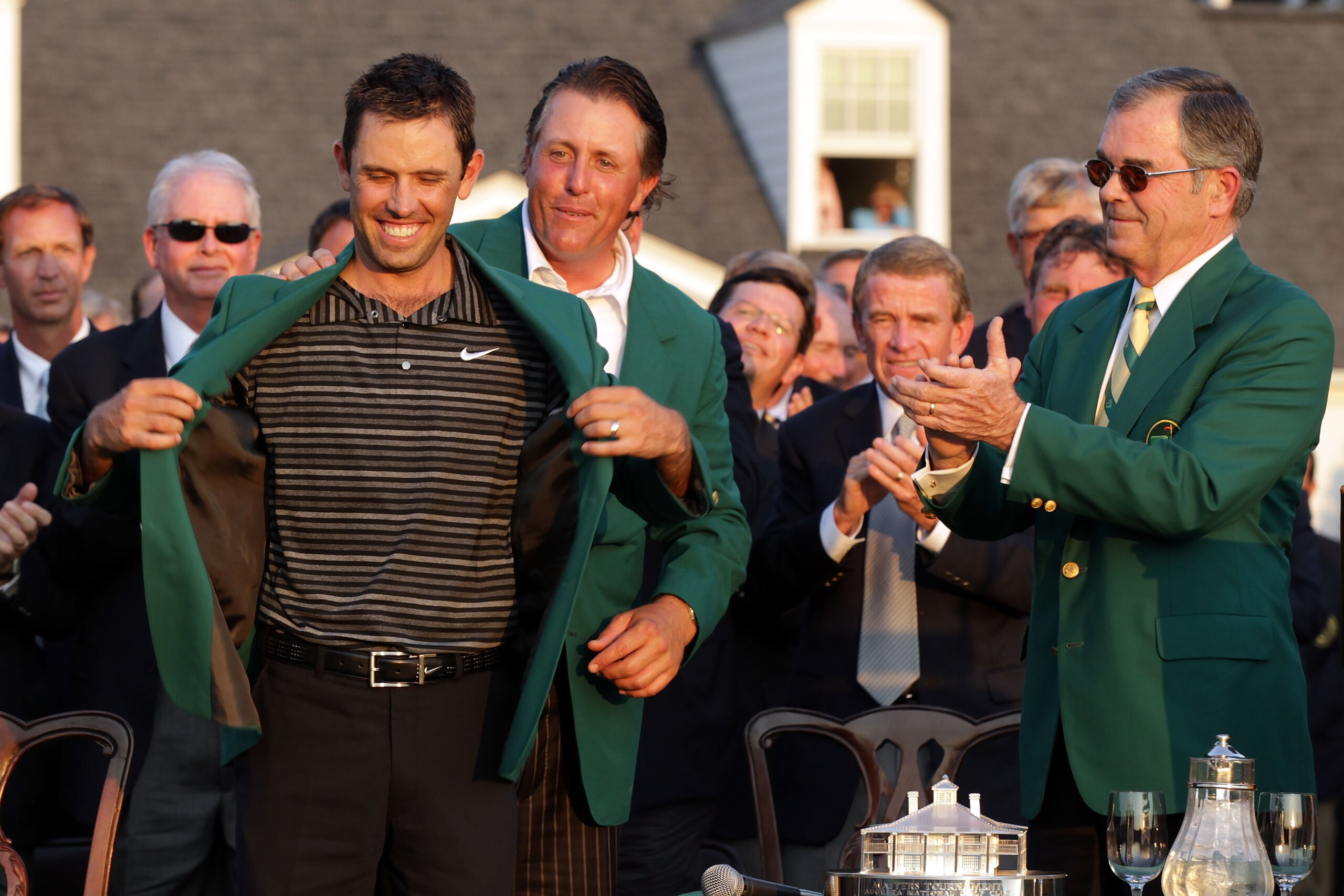 AUGUSTA, GA - APRIL 10:  Phil Mickelson (C) presents Charl Schwartzel of South Africa (L) the winner's jacket at the green jacket presentation as William Porter Payne looks on after Schwartzel's two-stroke victory at the 2011 Masters Tournament at Augusta