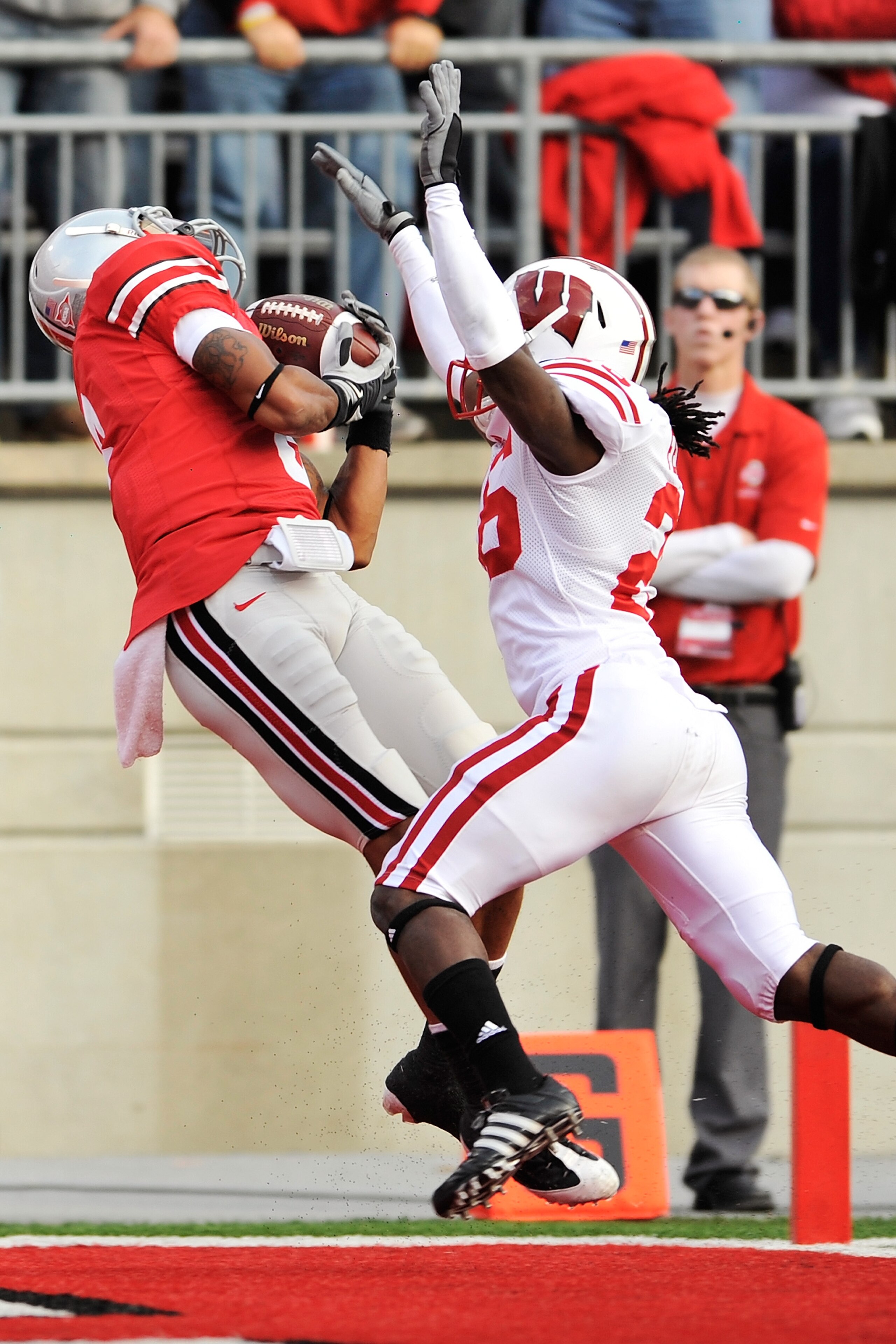 COLUMBUS, OH - OCTOBER 10:  DeVier Posey #8 of the Ohio State Buckeyes pulls in a 32-yard touchdown pass in front of Antonio Fenelus #26 of the Wisconsin Badgers at Ohio Stadium on October 10, 2009 in Columbus, Ohio.  (Photo by Jamie Sabau/Getty Images)