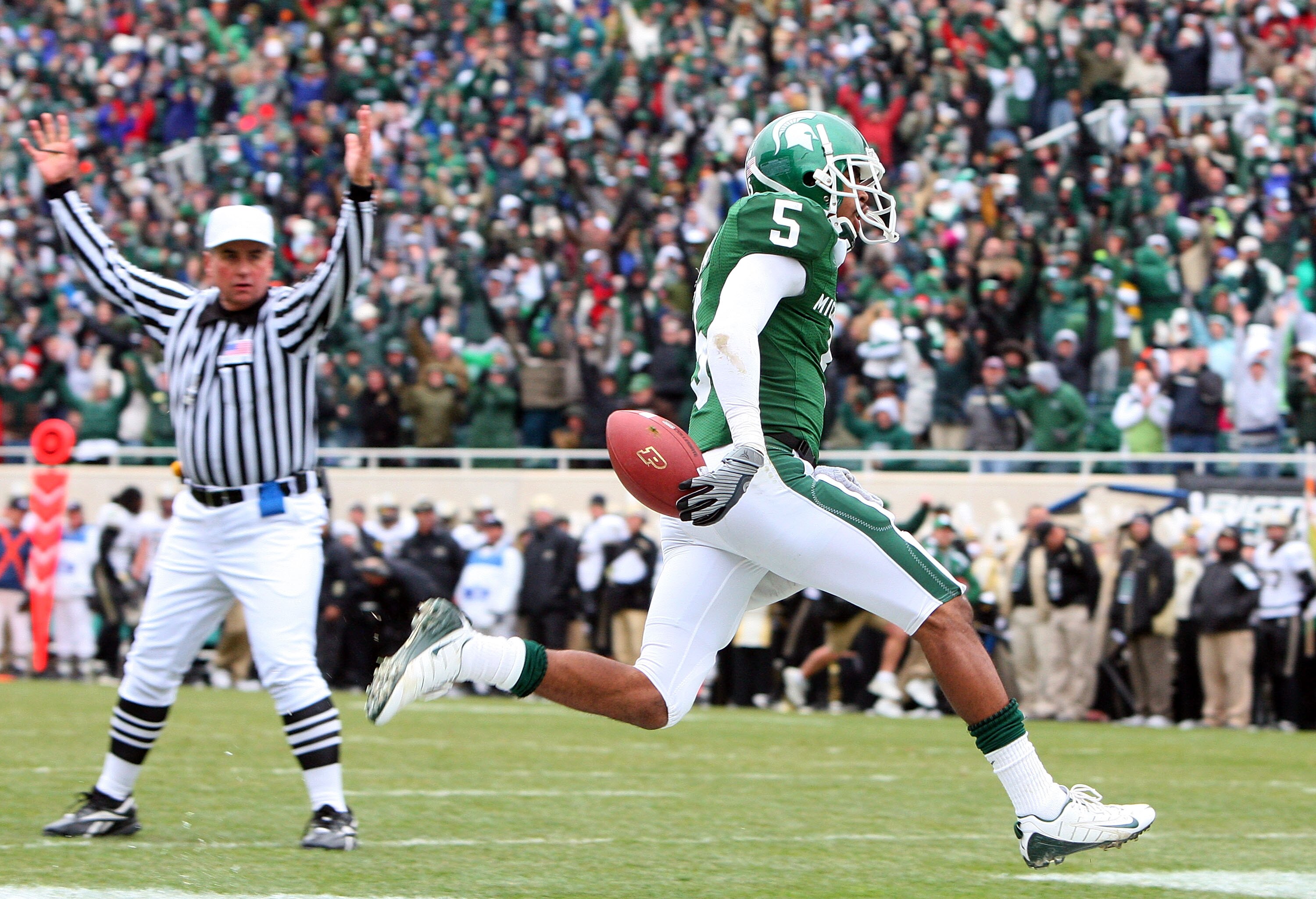 EAST LANSING, MI - NOVEMBER 08:  Johnny Adams #5of the Michigan State Spartans runs an interception against the Purdue Boilermakers for a touchdown at Spartan Stadium on November 8, 2008 in East Lansing, Michigan.  (Photo by Jim McIsaac/Getty Images)