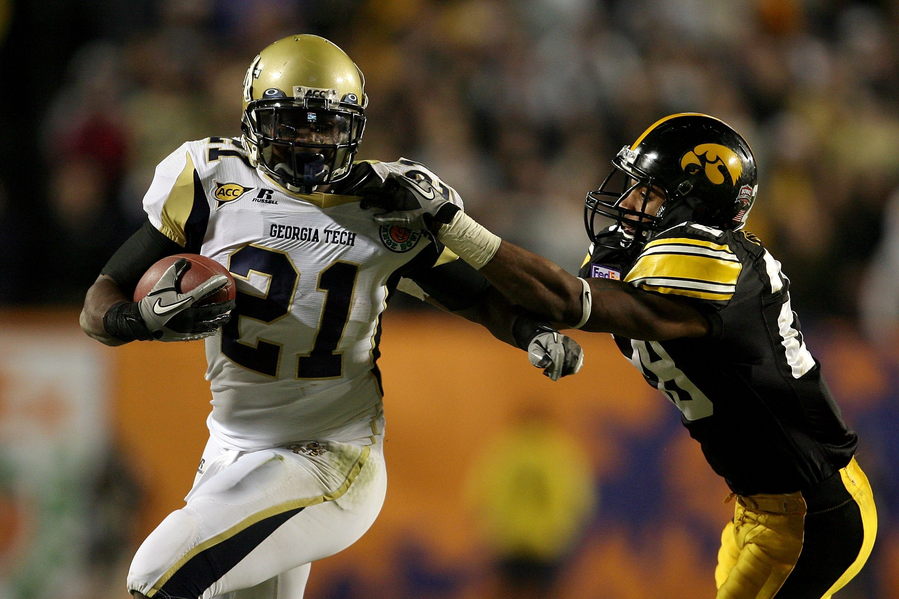 MIAMI GARDENS, FL - JANUARY 05:  Running back Jonathan Dwyer #21 of the Georgia Tech Yellow Jackets runs the ball against Shaun Prater #28 of the Iowa Hawkeyes during the FedEx Orange Bowl at Land Shark Stadium on January 5, 2010 in Miami Gardens, Florida