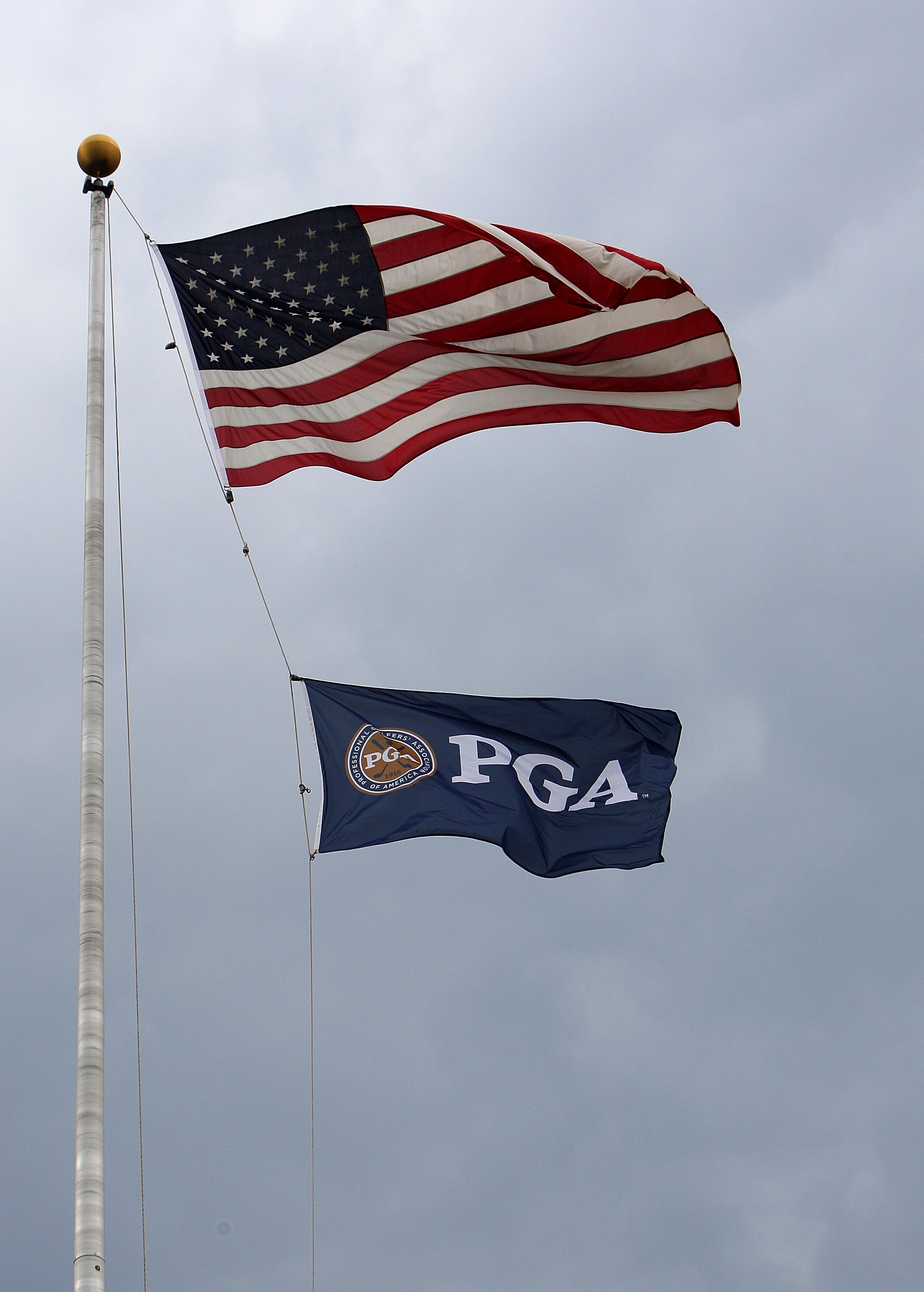 BLOOMFIELD HILLS, MI - AUGUST 09:  The American Flag and PGA of America Flag fly in the wind during a weather dellay during round three of the 90th PGA Championship at Oakland Hills Country Club on August 9, 2008 in Bloomfield Township, Michigan.  (Photo
