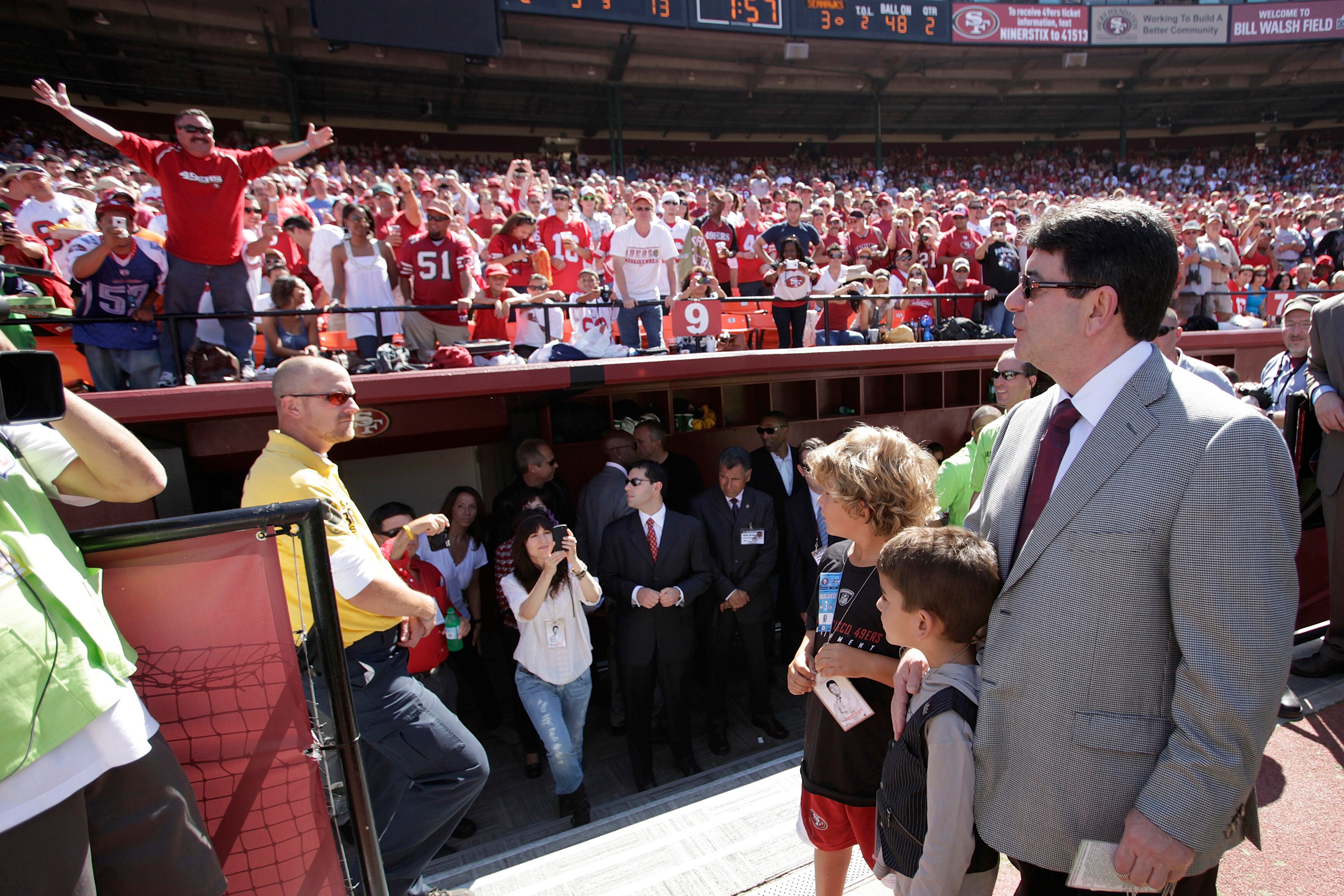 SAN FRANCISCO - SEPTEMBER 20:  Eddie DeBartolo Jr, (R) former owner of the San Francisco 49ers, looks up at the stands as fans greet him just before half time during home opener as the San Francisco 49ers host the Seattle Seahawks at Candlestick Park Sept