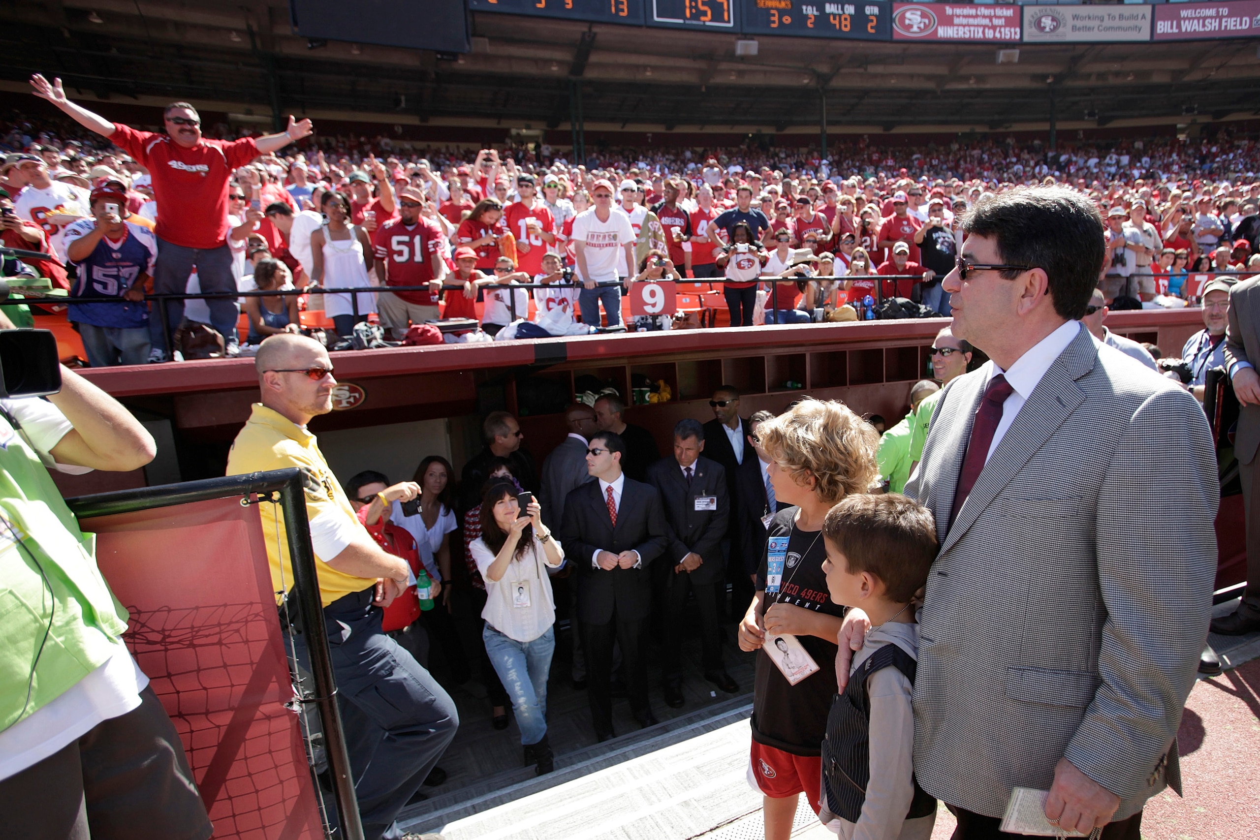 SAN FRANCISCO - SEPTEMBER 20:  Eddie DeBartolo Jr, (R) former owner of the San Francisco 49ers, looks up at the stands as fans greet him just before half time during home opener as the San Francisco 49ers host the Seattle Seahawks at Candlestick Park Sept