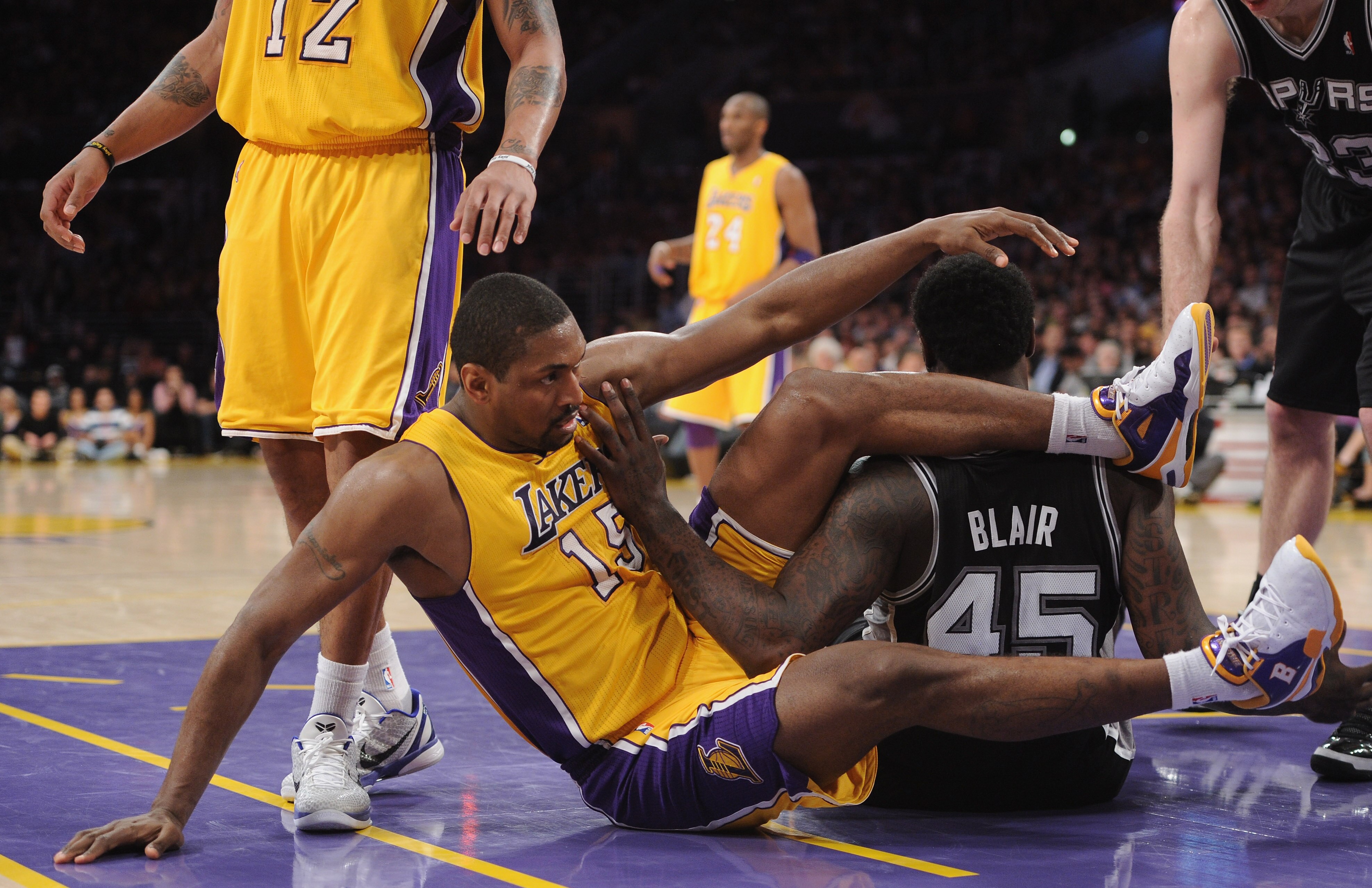 LOS ANGELES, CA - APRIL 12:  Ron Artest #15 of the Los Angeles Lakers and DeJuan Blair #45 of the San Antonio Spurs get tangled at Staples Center on April 12, 2011 in Los Angeles, California.  NOTE TO USER: User expressly acknowledges and agrees that, by