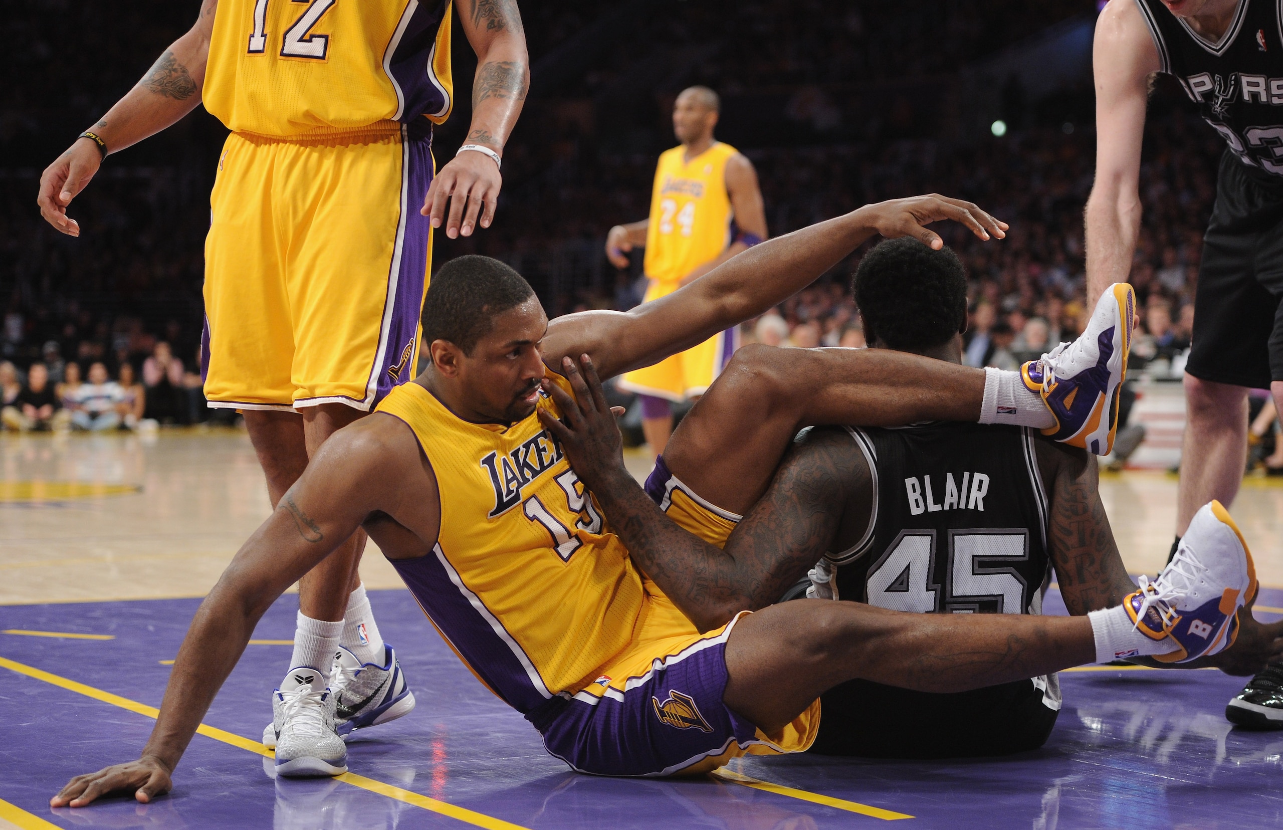 LOS ANGELES, CA - APRIL 12:  Ron Artest #15 of the Los Angeles Lakers and DeJuan Blair #45 of the San Antonio Spurs get tangled at Staples Center on April 12, 2011 in Los Angeles, California.  NOTE TO USER: User expressly acknowledges and agrees that, by