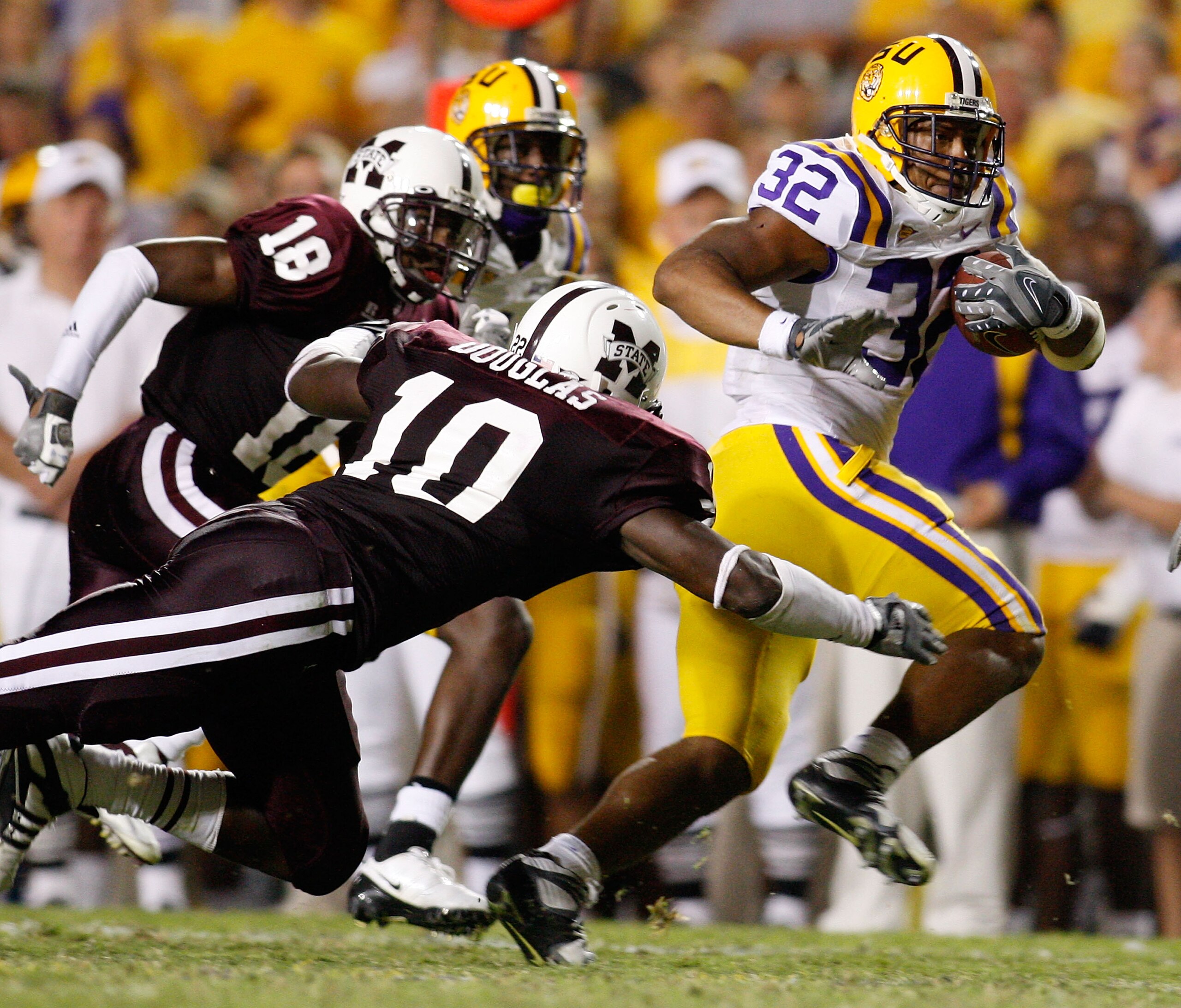 BATON ROUGE, LA - SEPTEMBER 27: David Impastato #32 of the Louisiana State University Tigers avoids a tackle by Dominic Douglas #10 of the Mississippi State Bulldogs on September 27, 2008 at Tiger Stadium in Baton Rouge, Louisiana. LSU defeated Mississi BATON ROUGE, LA - SEPTEMBER 27: David Impastato #32 of the Louisiana State University Tigers avoids a tackle by Dominic Douglas #10 of the Mississippi State Bulldogs on September 27, 2008 at Tiger Stadium in Baton Rouge, Louisiana. LSU defeated Mississi