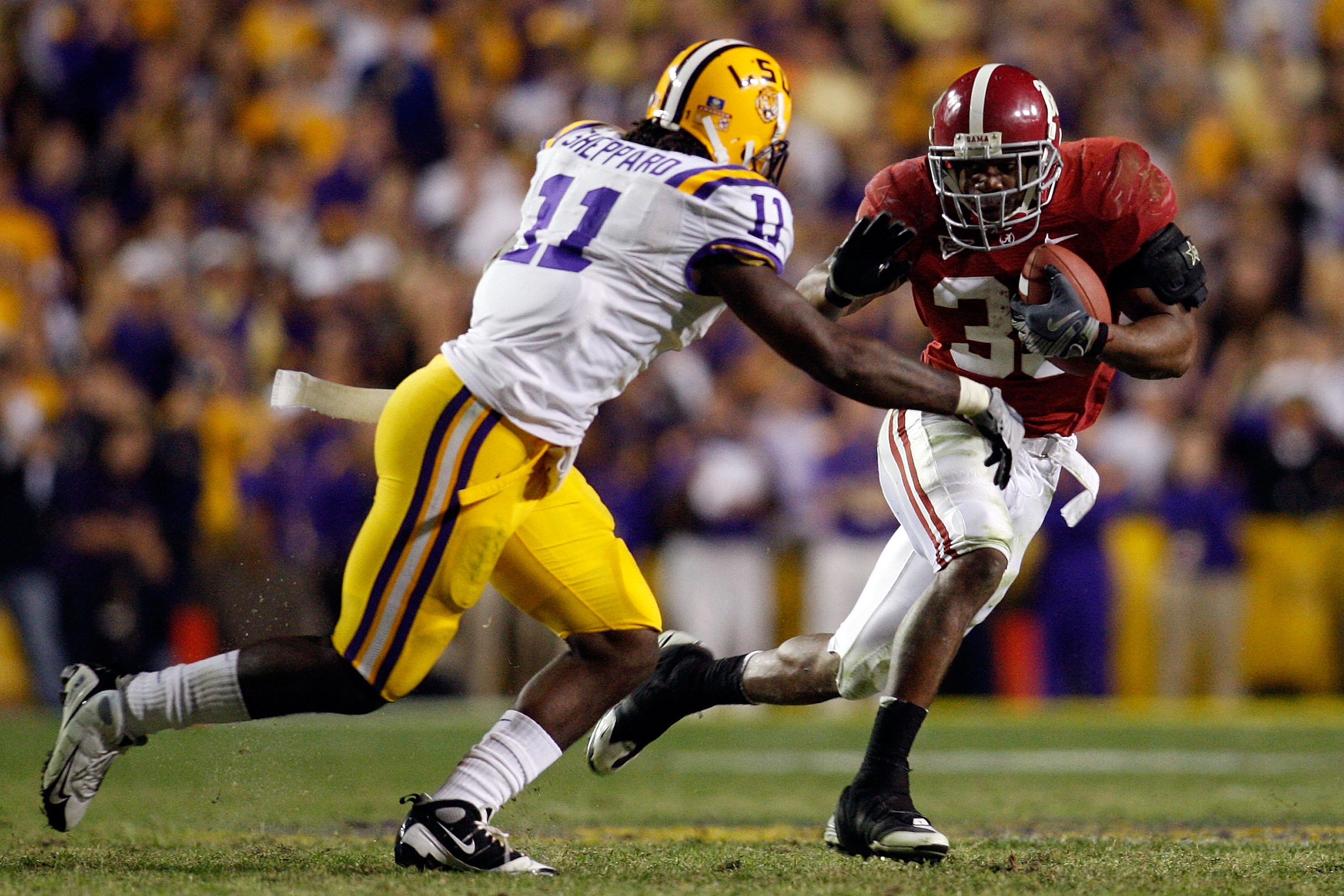 BATON ROUGE, LA - NOVEMBER 08: Glen Coffee #38 of the Alabama Crimson Tide tries to avoid a tackle by Kelvin Sheppard #11 of the Louisiana State University Tigers on November 11, 2008 at Tiger Stadium in Baton Rouge, Louisiana. The Tide defeated the Tige BATON ROUGE, LA - NOVEMBER 08: Glen Coffee #38 of the Alabama Crimson Tide tries to avoid a tackle by Kelvin Sheppard #11 of the Louisiana State University Tigers on November 11, 2008 at Tiger Stadium in Baton Rouge, Louisiana. The Tide defeated the Tige