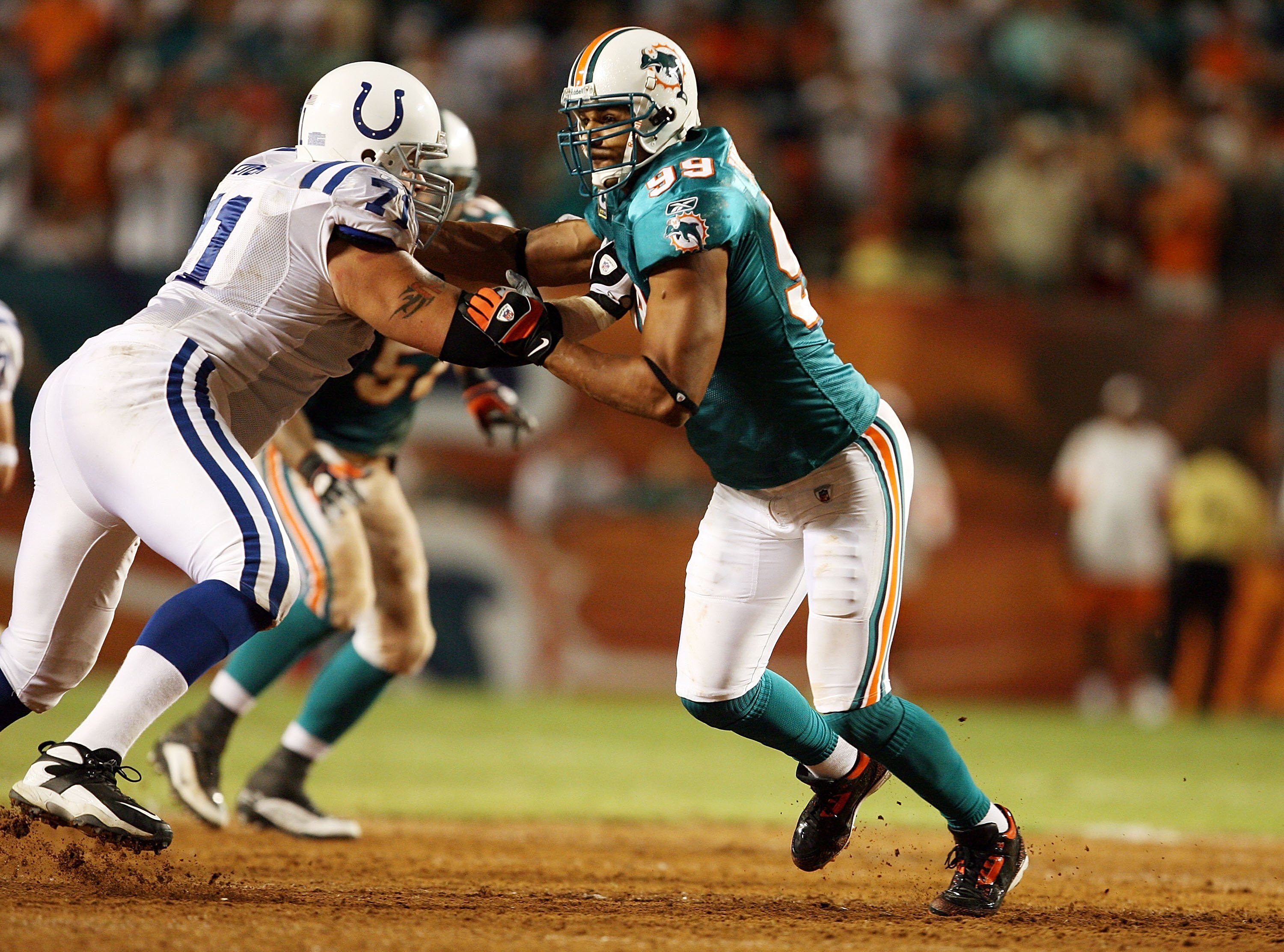 MIAMI - SEPTEMBER 21:  Offensive lineman Ryan Diem #71 of the Indianapolis Colts tries to stop linebacker Jason Taylor #99 of the Miami Dolphins at Land Shark Stadium on September 21, 2009 in Miami, Florida. The Colts defeated the Dolphins 27-23.  (Photo