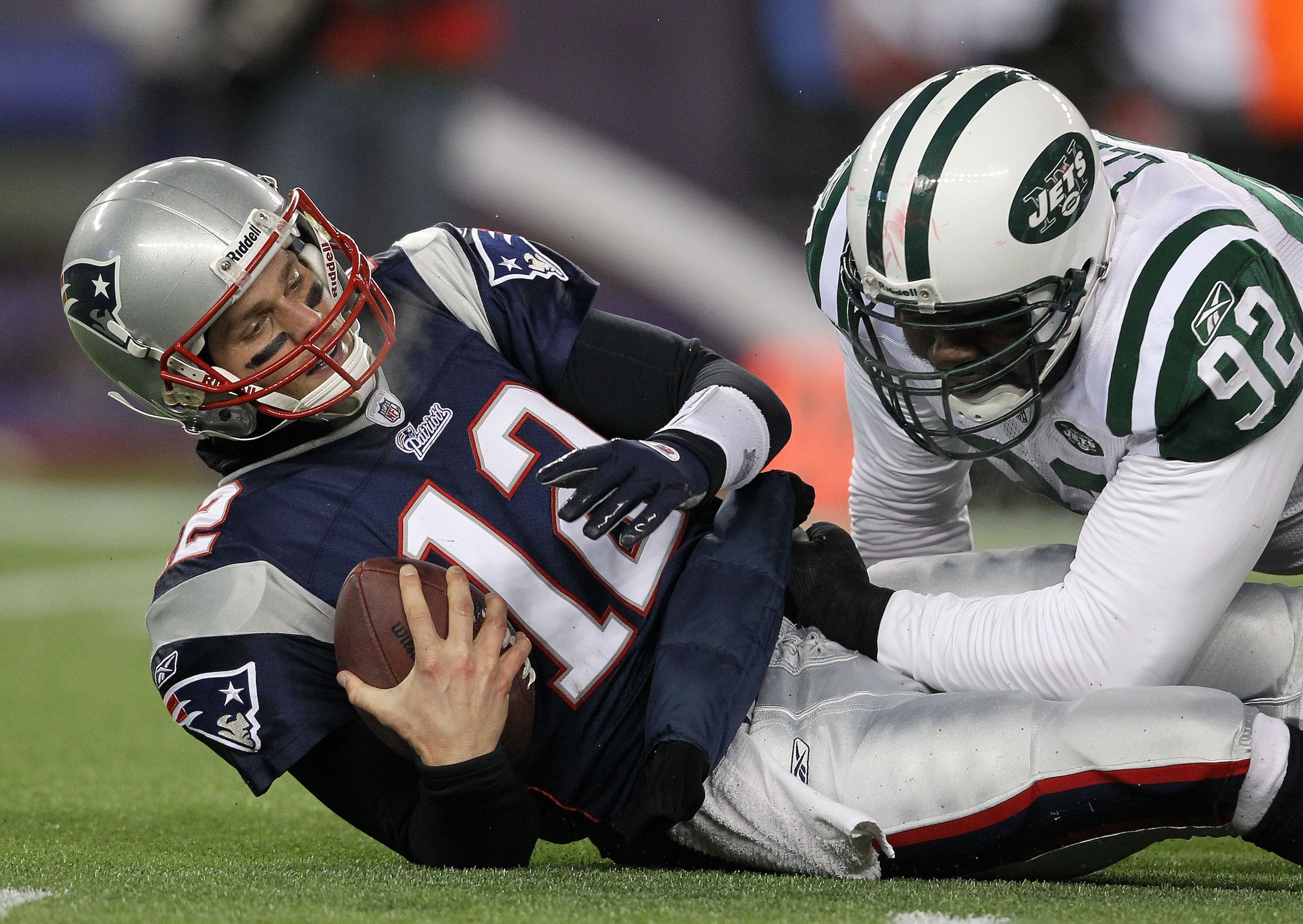 FOXBORO, MA - JANUARY 16: Quarterback Tom Brady #12 of the New England Patriots is sacked by Shaun Ellis #92 of the New York Jets during their 2011 AFC divisional playoff game at Gillette Stadium on January 16, 2011 in Foxboro, Massachusetts. (Photo by FOXBORO, MA - JANUARY 16: Quarterback Tom Brady #12 of the New England Patriots is sacked by Shaun Ellis #92 of the New York Jets during their 2011 AFC divisional playoff game at Gillette Stadium on January 16, 2011 in Foxboro, Massachusetts. (Photo by