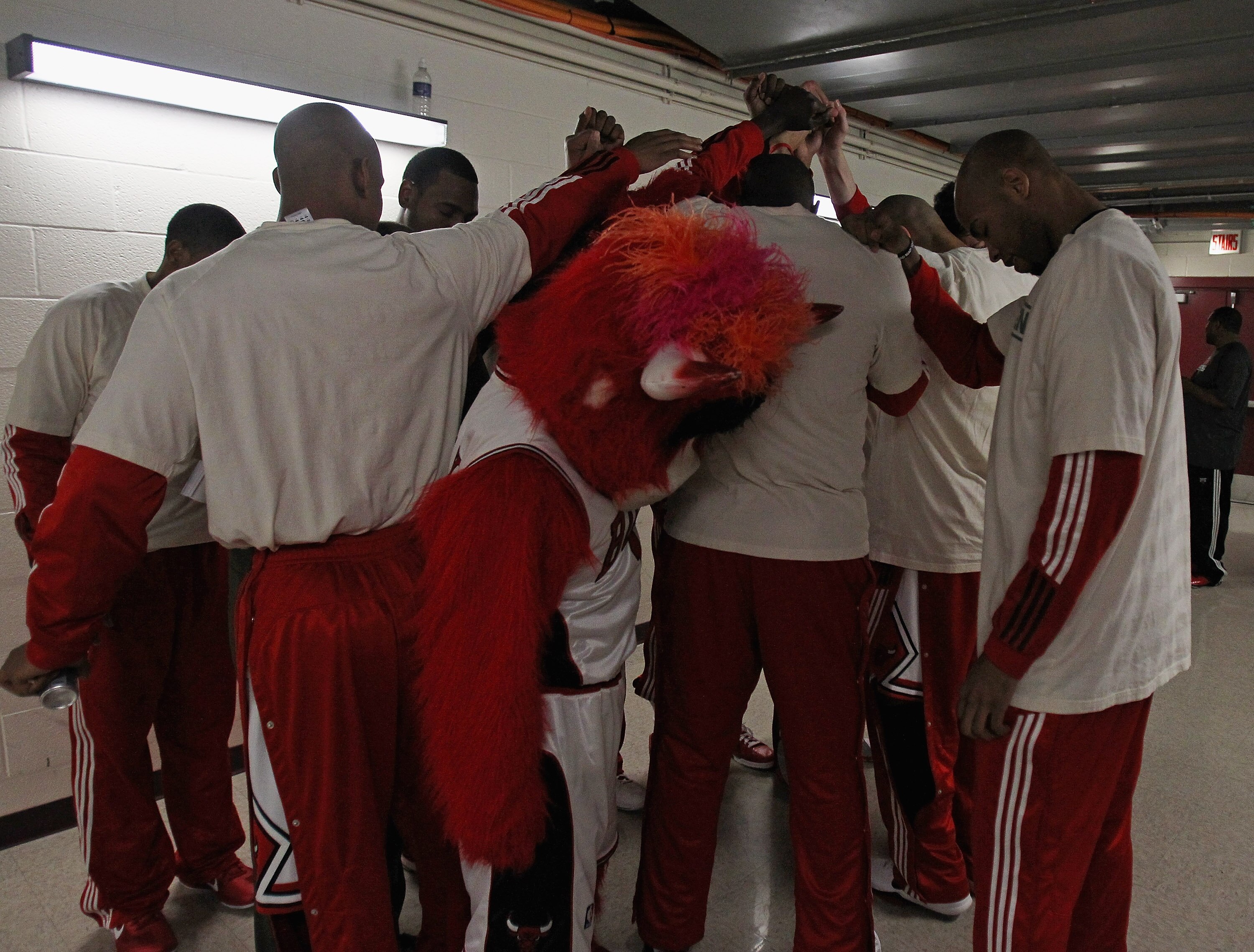 CHICAGO, IL - APRIL 07: Members of the Chicago Bulls including mascot 'Benny,' say a prayer before entering the court for warm-ups for a game against the Boston Celtics at United Center on April 7, 2011 in Chicago, Illinois. NOTE TO USER: User expressly a