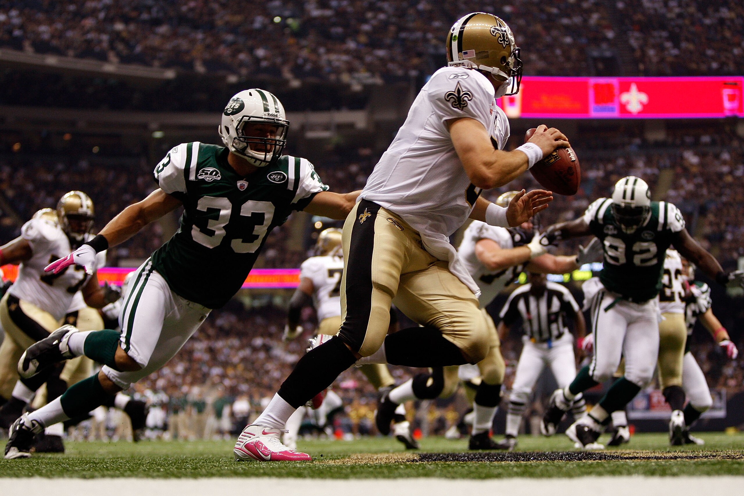 NEW ORLEANS - OCTOBER 04: Drew Brees #9 of the New Orleans Saints avoids a tackle by Eric Smith #33 of the New York Jets at the Louisana Superdome on October 4, 2009 in New Orleans, Louisiana. (Photo by Chris Graythen/Getty Images) NEW ORLEANS - OCTOBER 04: Drew Brees #9 of the New Orleans Saints avoids a tackle by Eric Smith #33 of the New York Jets at the Louisana Superdome on October 4, 2009 in New Orleans, Louisiana. (Photo by Chris Graythen/Getty Images)