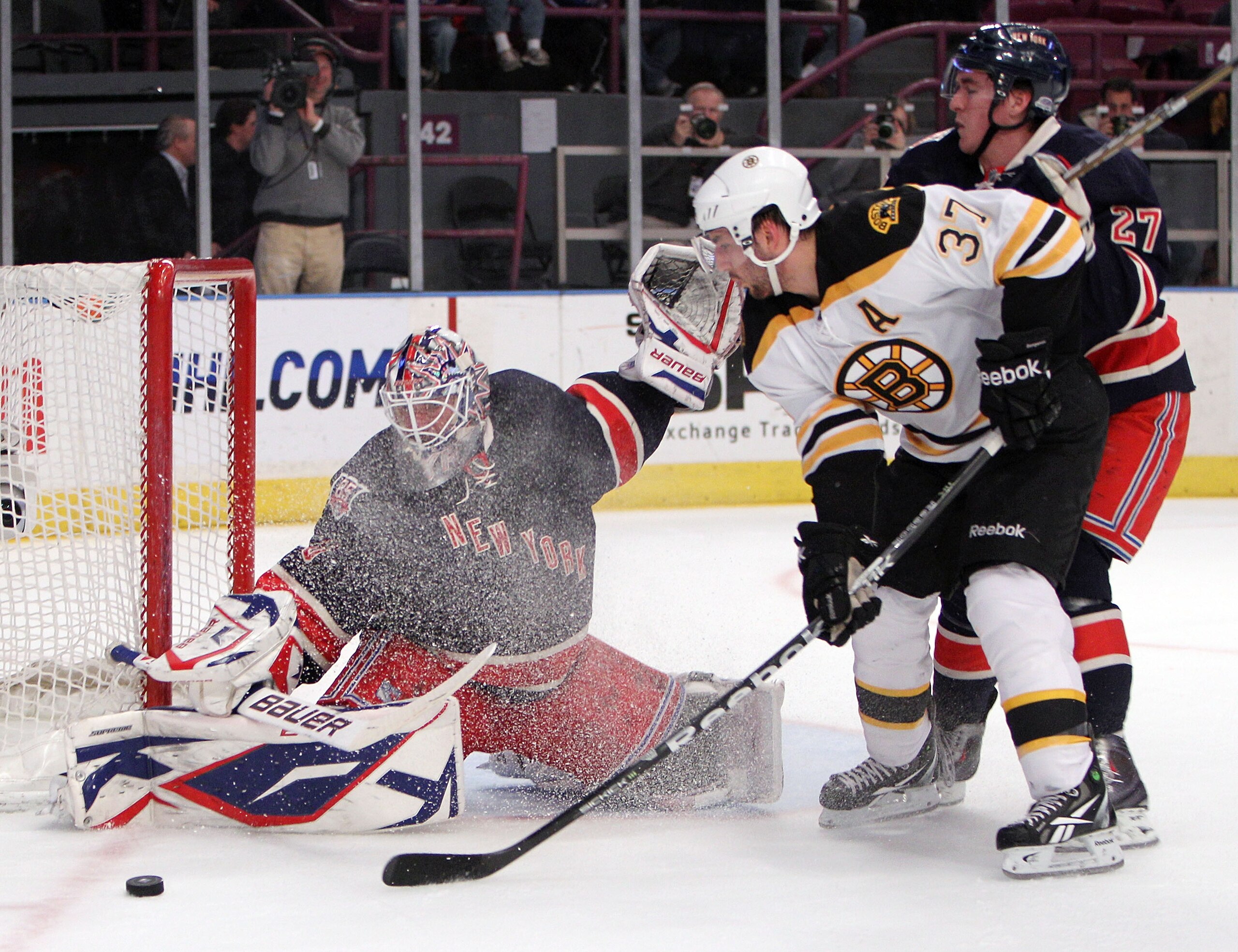 NEW YORK, NY - APRIL 04: Patrice Bergeron #37 of the Boston Bruins is stopped by Henrik Lundqvist #30 of the New York Rangers during the first period at Madison Square Garden on April 4, 2011 in New York City.  (Photo by Bruce Bennett/Getty Images)