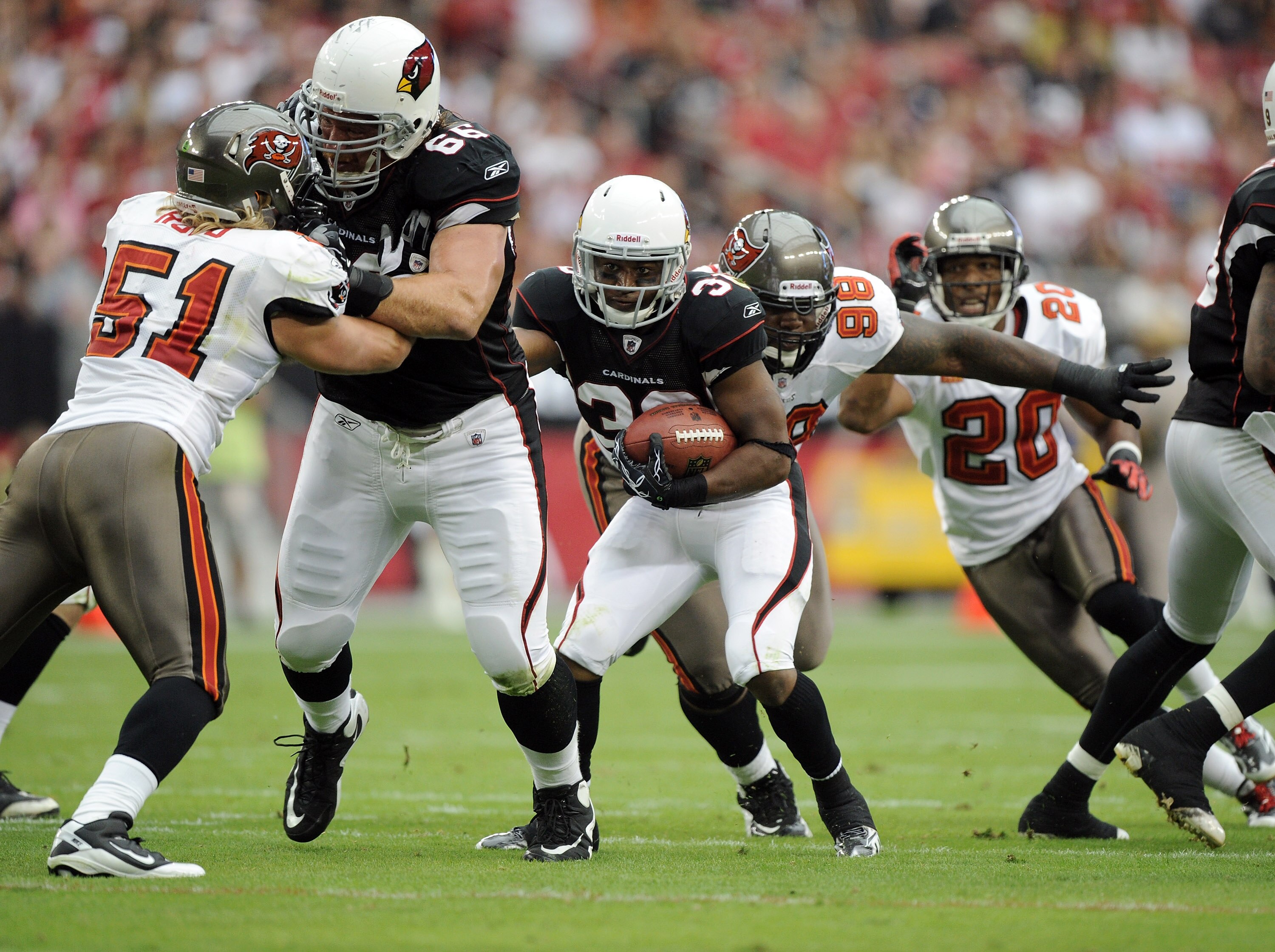 GLENDALE, AZ - OCTOBER 31:  LaRod Stephens-Howling #36 of the Arizona Cardinals gets a block from Alan Faneca #66 as he attempts to elude Barrett Ruud #51 and Ryan Sims #98 of the Tampa Bay Buccaneers at University of Phoenix Stadium on October 31, 2010 i
