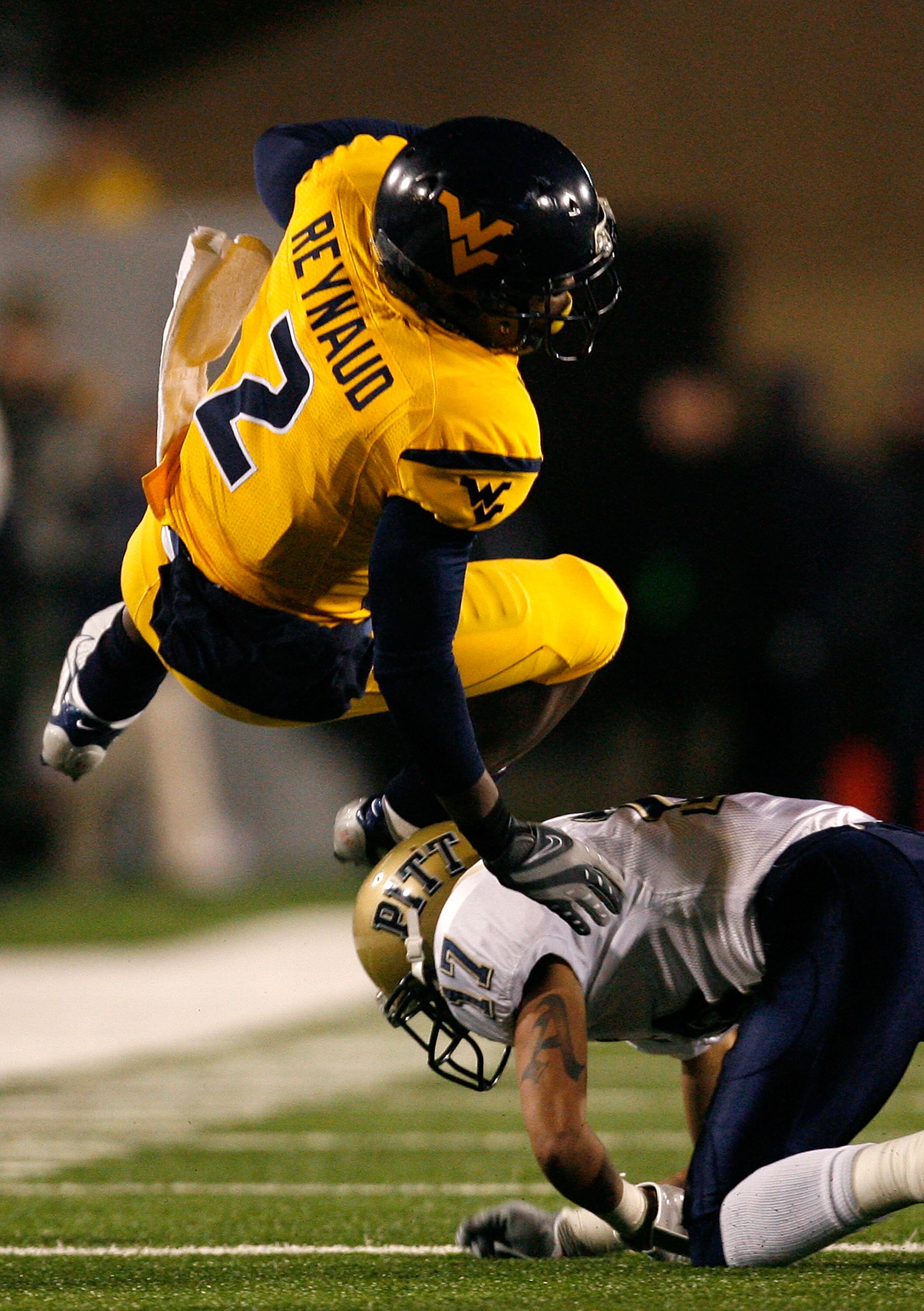 MORGANTOWN, WV - DECEMBER 1:  Defensive back Aaron Berry #17 of the Pittsburgh Panthers upends receiver Darius Reynaud # 2 of the West Virginia Mountaineers during the second half at Milan Puskar Stadium December 1, 2007 in Morgantown, West Virginia.  Pit