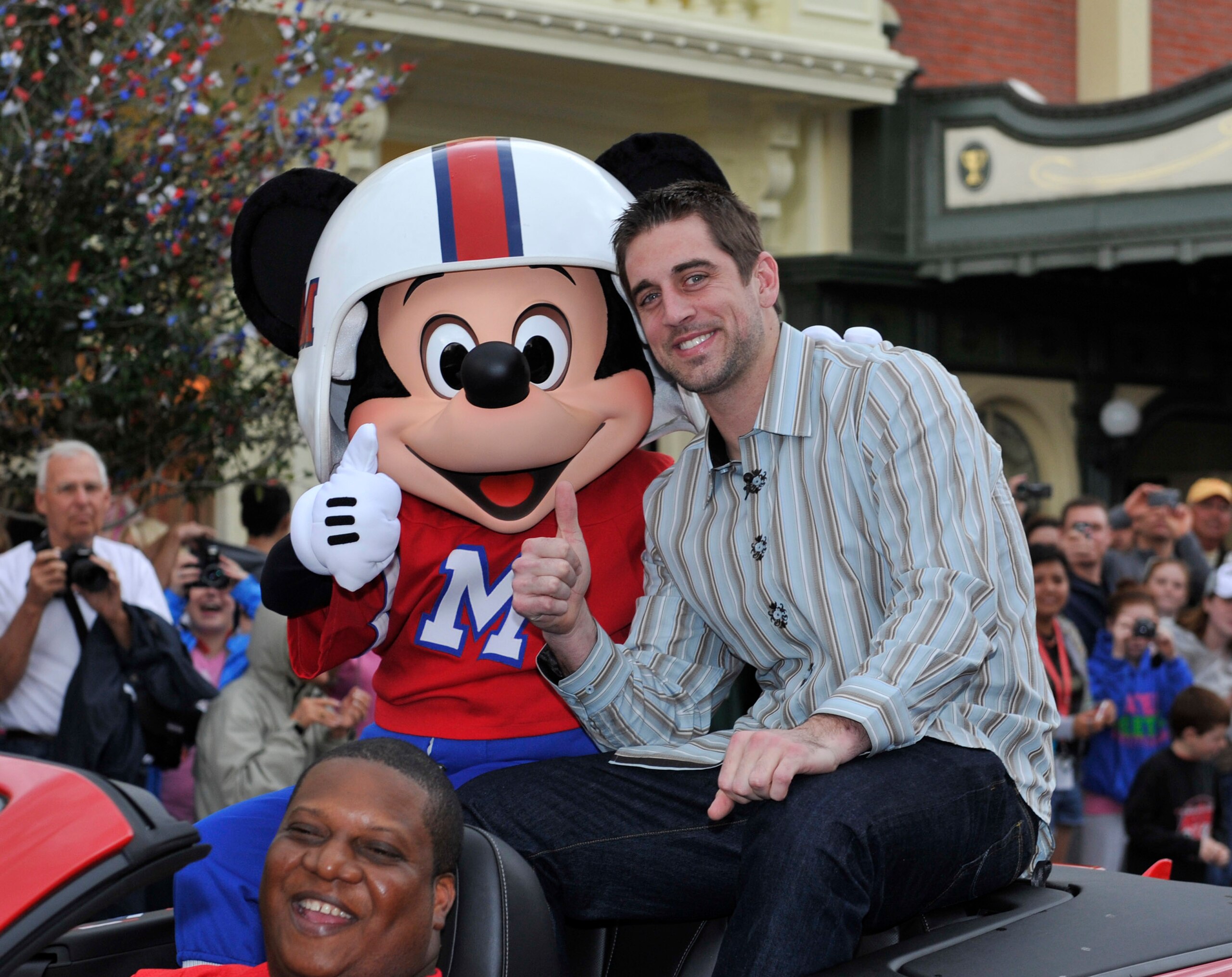 LAKE BUENA VISTA, FL - FEBRUARY 07:  In this handout photo provided by Disney, Super Bowl XLV Most Valuable Player Aaron Rodgers takes a celebratory ride with Mickey Mouse, following the Green Bay Packers' 31-25 victory over the Pittsburgh Steelers Februa