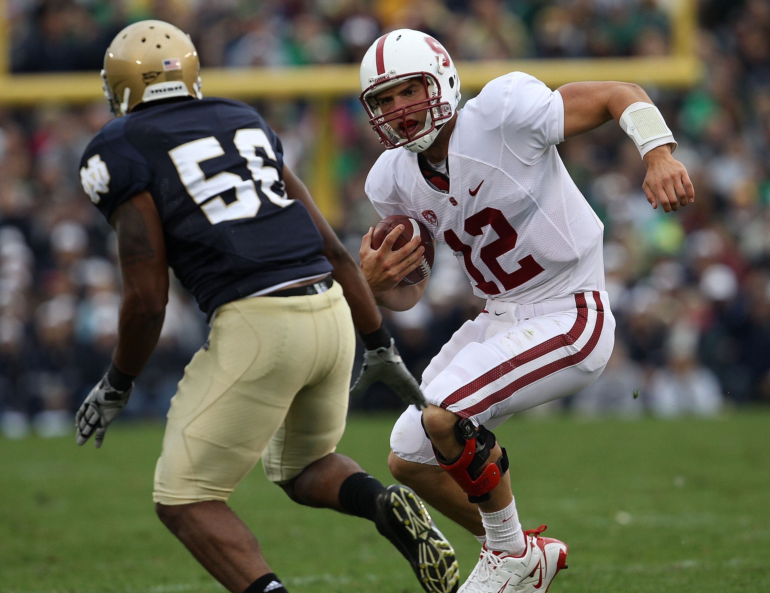 SOUTH BEND, IN - SEPTEMBER 25: Andrew Luck #12 of the Stanford Cardinal runs for yardage as Kerry Neal #56 of the Notre Dame Fighting Irish closes in at Notre Dame Stadium on September 25, 2010 in South Bend, Indiana. Stanford defeated Notre Dame 37-14. ( SOUTH BEND, IN - SEPTEMBER 25: Andrew Luck #12 of the Stanford Cardinal runs for yardage as Kerry Neal #56 of the Notre Dame Fighting Irish closes in at Notre Dame Stadium on September 25, 2010 in South Bend, Indiana. Stanford defeated Notre Dame 37-14. (
