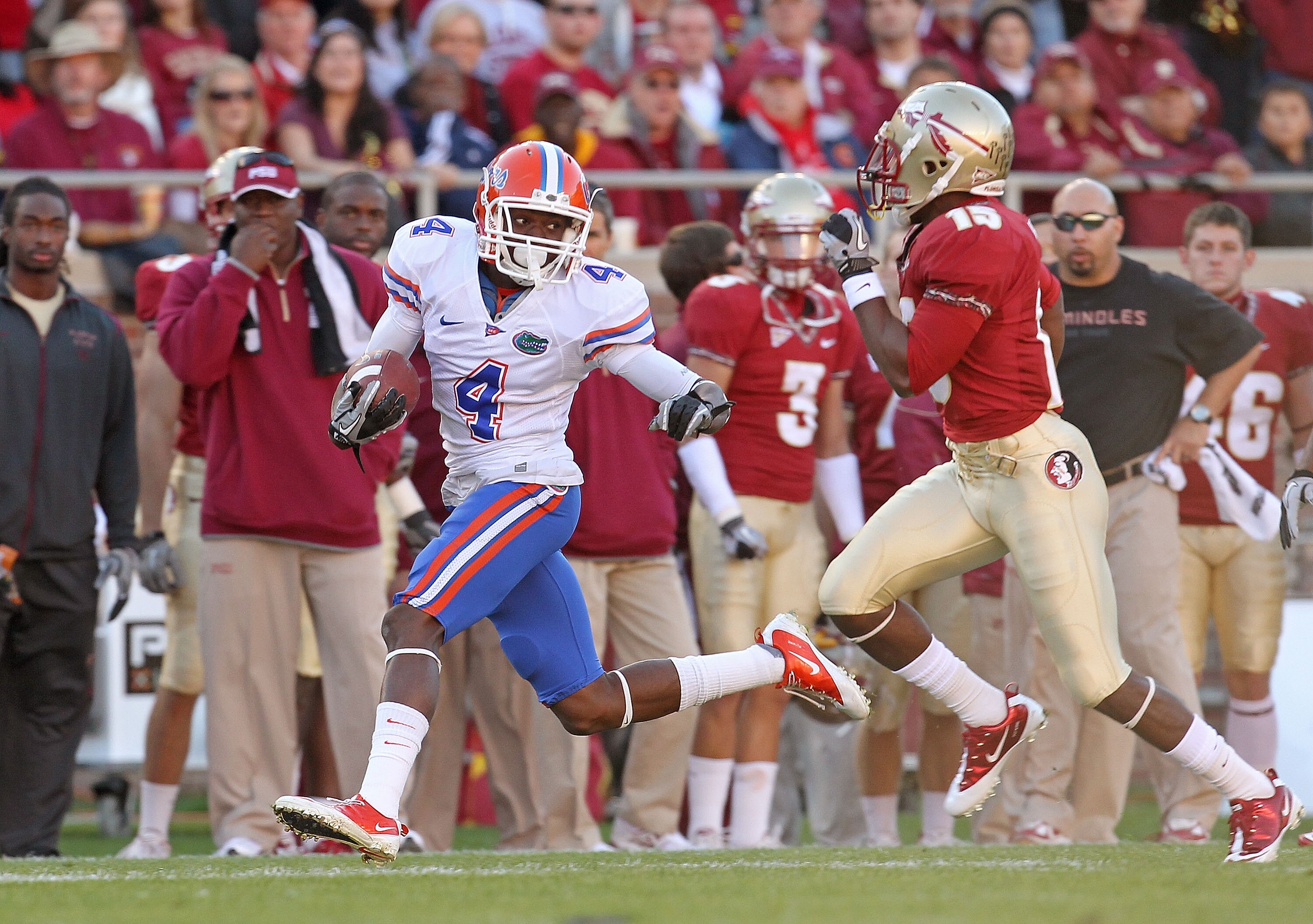 TALLAHASSEE, FL - NOVEMBER 27:  Andre Debose #4 of the Florida Gators rushes after a catch before being forced out of bounds by  Ochuko Jenije #15 of the Florida State Seminoles during a game at Doak Campbell Stadium on November 27, 2010 in Tallahassee, F