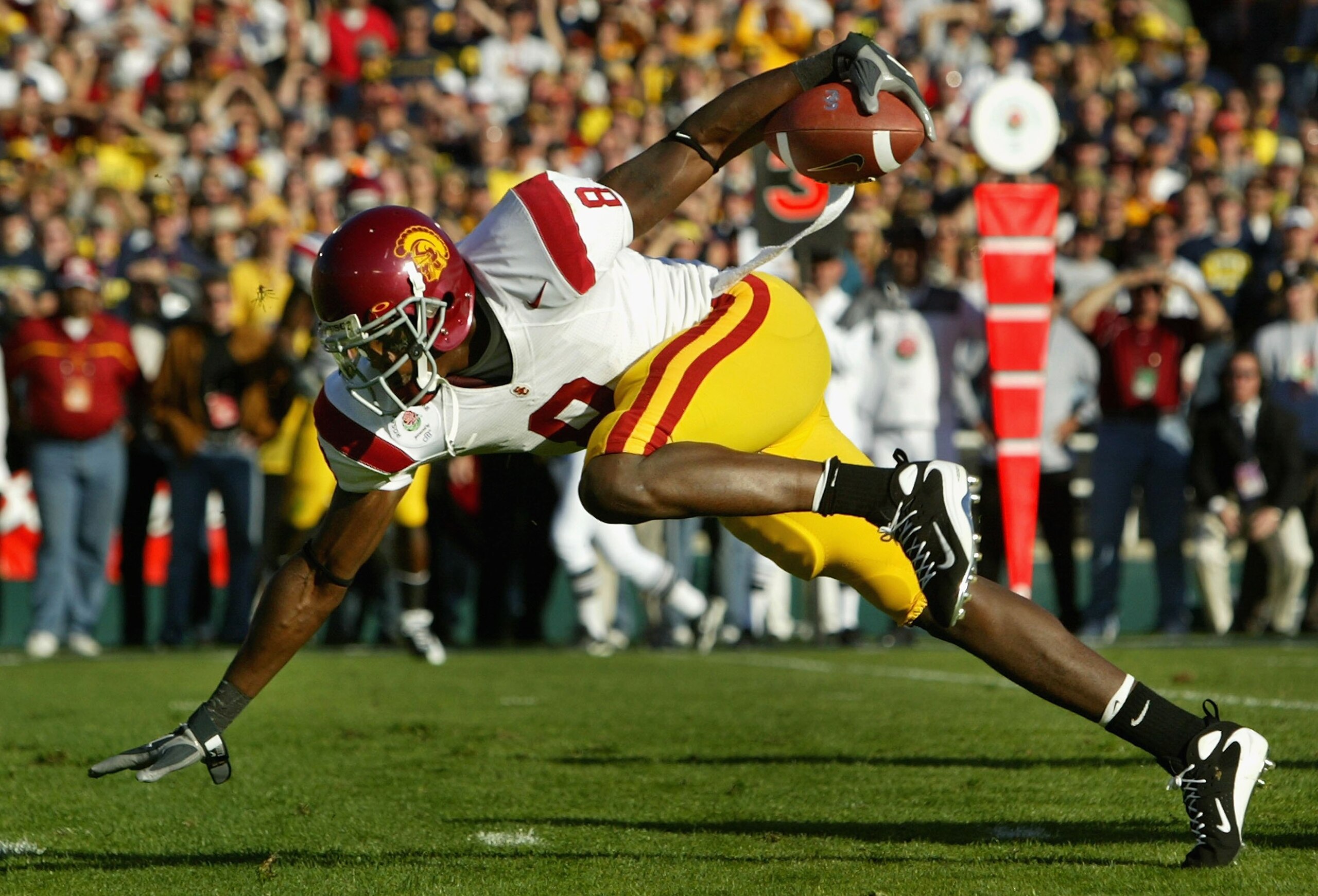 PASADENA, CA - JANUARY 01:  Dwayne Jarrett #8 of the USC Trojans falls after a 18 yard completion against the Michigan Wolverines during the Rose Bowl game on January 1, 2007 at the Rose Bowl in Pasadena, California. The Trojans defeated the Wolverines 32