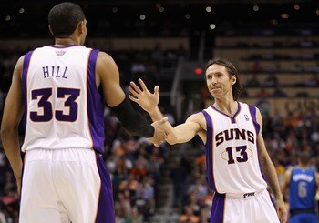 PHOENIX, AZ - MARCH 27:  Steve Nash #13 of the Phoenix Suns high fives teammate Grant Hill #33 during the NBA game against the Dallas Mavericks at US Airways Center on March 27, 2011 in Phoenix, Arizona. The Mavericks defeated the Suns 91-83.  NOTE TO USE