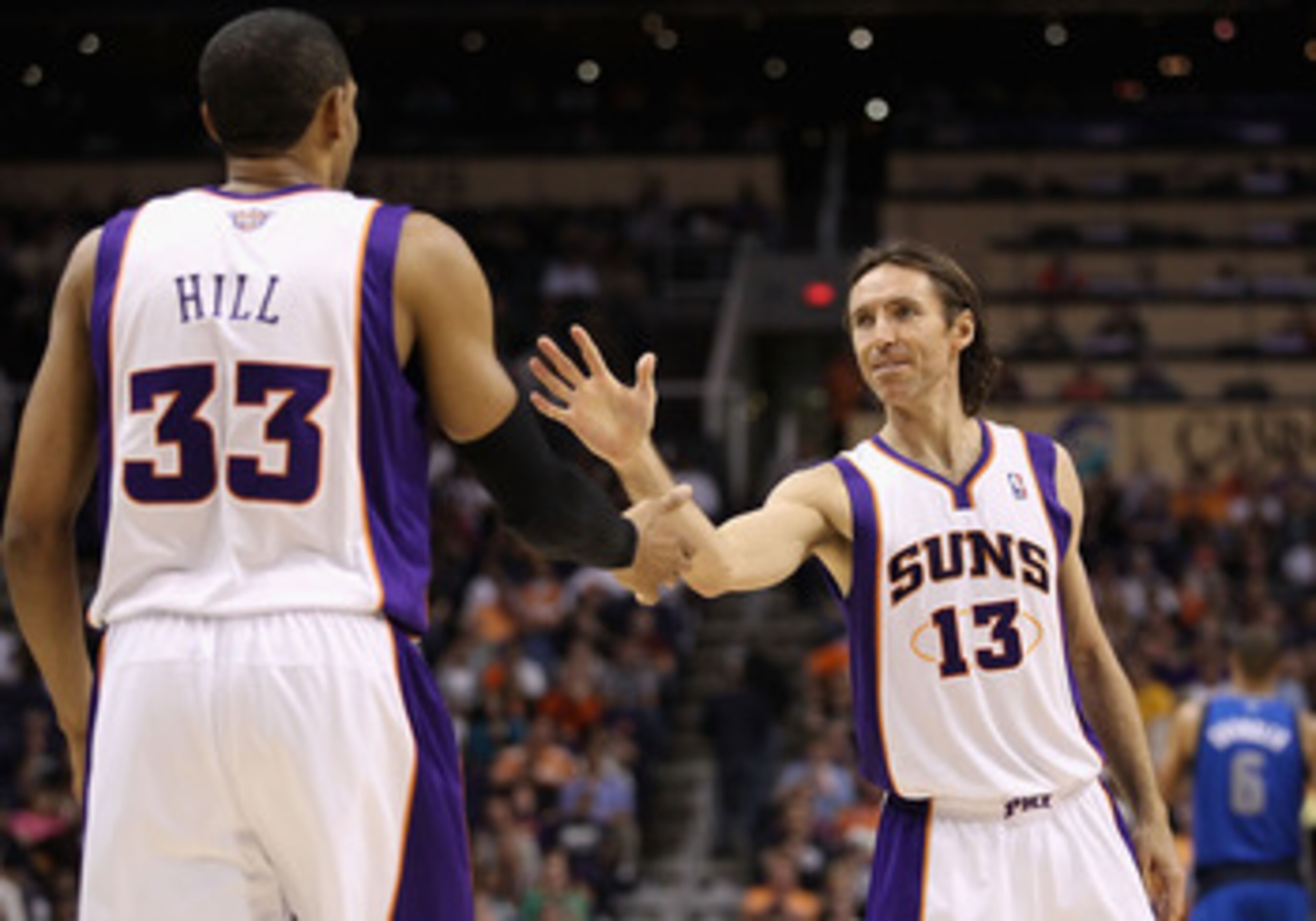 PHOENIX, AZ - MARCH 27:  Steve Nash #13 of the Phoenix Suns high fives teammate Grant Hill #33 during the NBA game against the Dallas Mavericks at US Airways Center on March 27, 2011 in Phoenix, Arizona. The Mavericks defeated the Suns 91-83.  NOTE TO USE