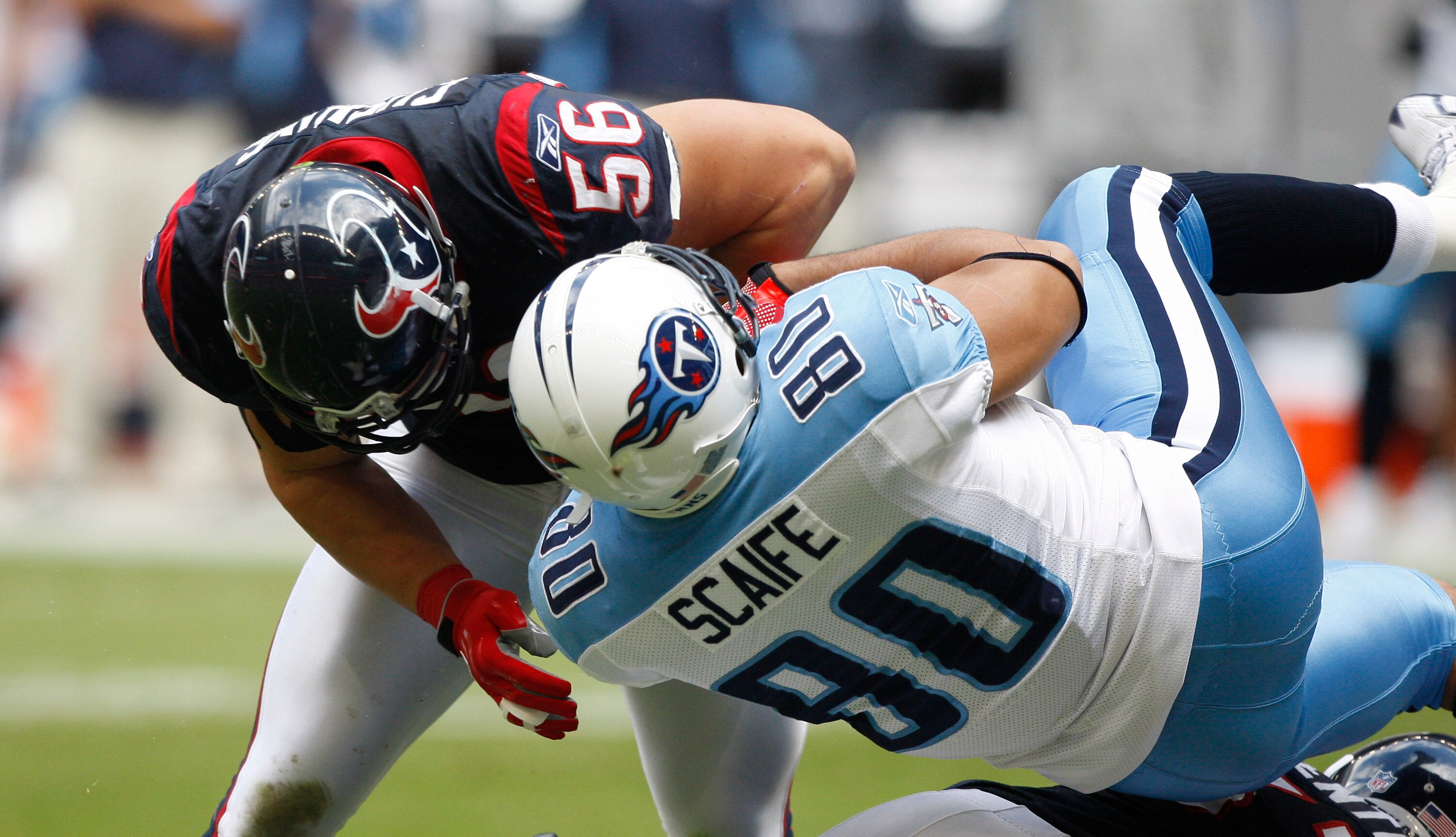 HOUSTON - NOVEMBER 28:  Linebacker Brian Cushing #56 of the Houston Texans lays a hard hit on tight end Bo Scaife #80 of the Tennessee Titans at Reliant Stadium on November 28, 2010 in Houston, Texas.  (Photo by Bob Levey/Getty Images)