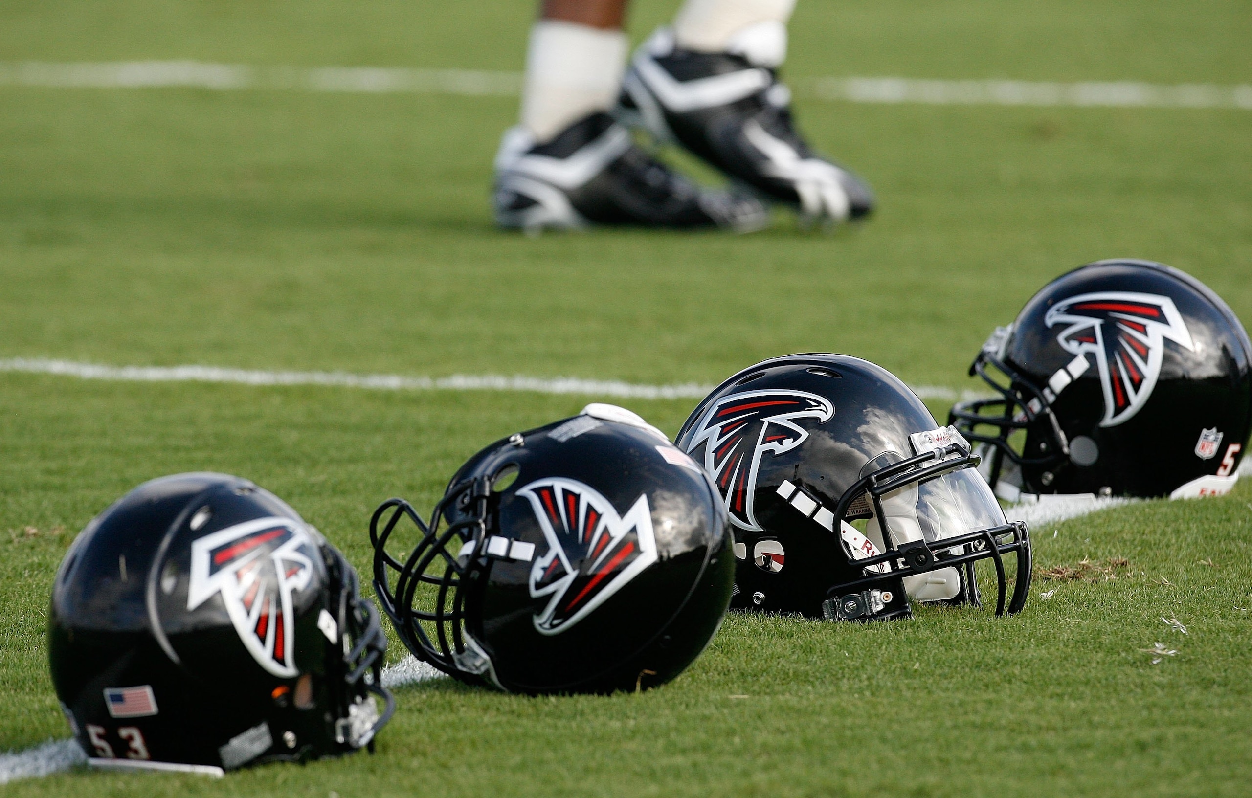 FLOWERY BRANCH, GA - AUGUST 01:  Atlanta Falcons' helmets sit on field during opening day of training camp on August 1, 2009 at the Falcons Training Complex in Flowery Branch, Georgia.  (Photo by Kevin C. Cox/Getty Images)