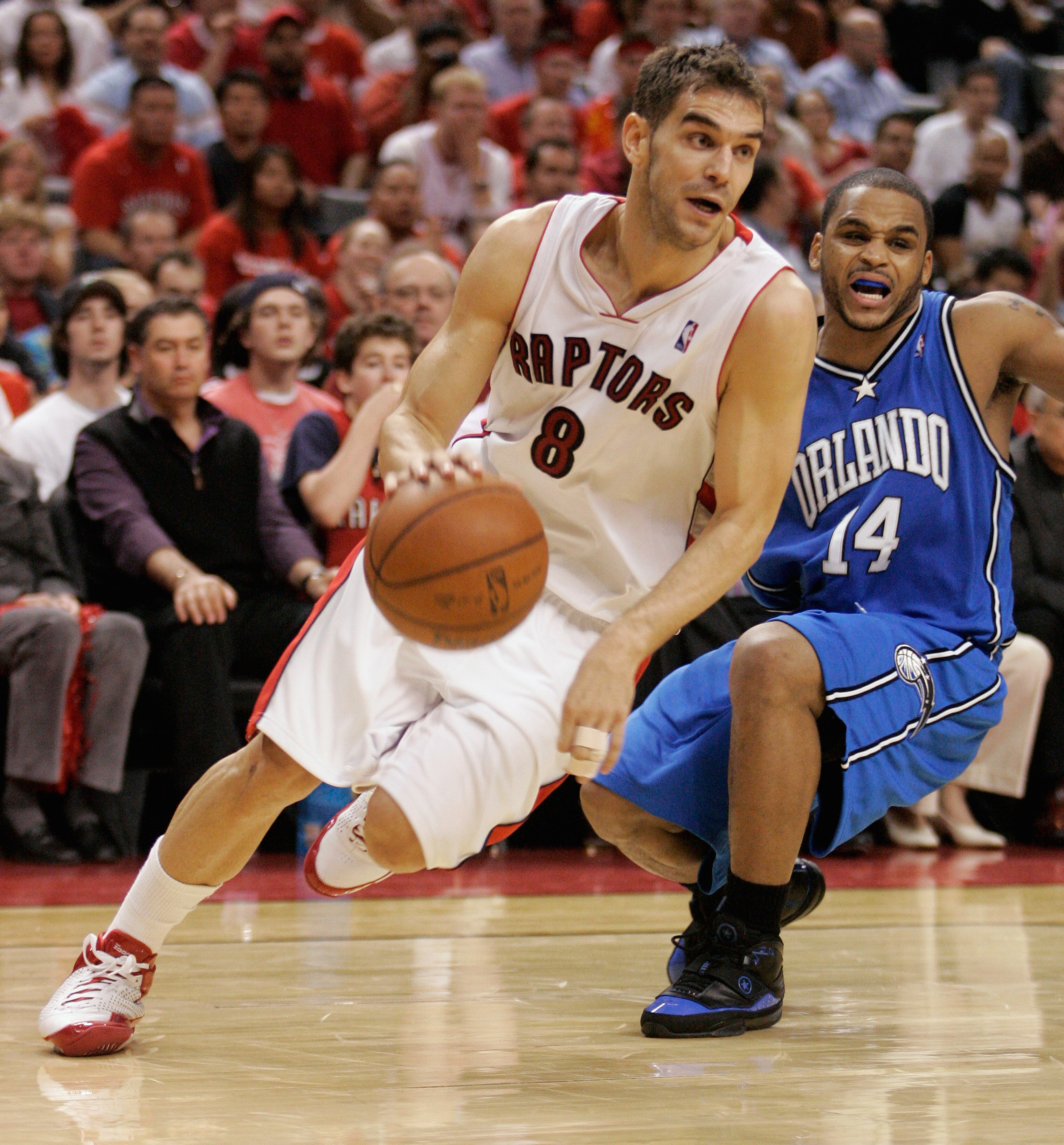 TORONTO, ON - APRIL 26:  Jose Calderon #8 of the Toronto Raptors drives past Jameer Nelson #14 of the Orlando Magic in Game Four of the Eastern Conference Quarterfinals at the Air Canada Centre April 26, 2008 in Toronto, Ontario. The Magic defeated the Ra