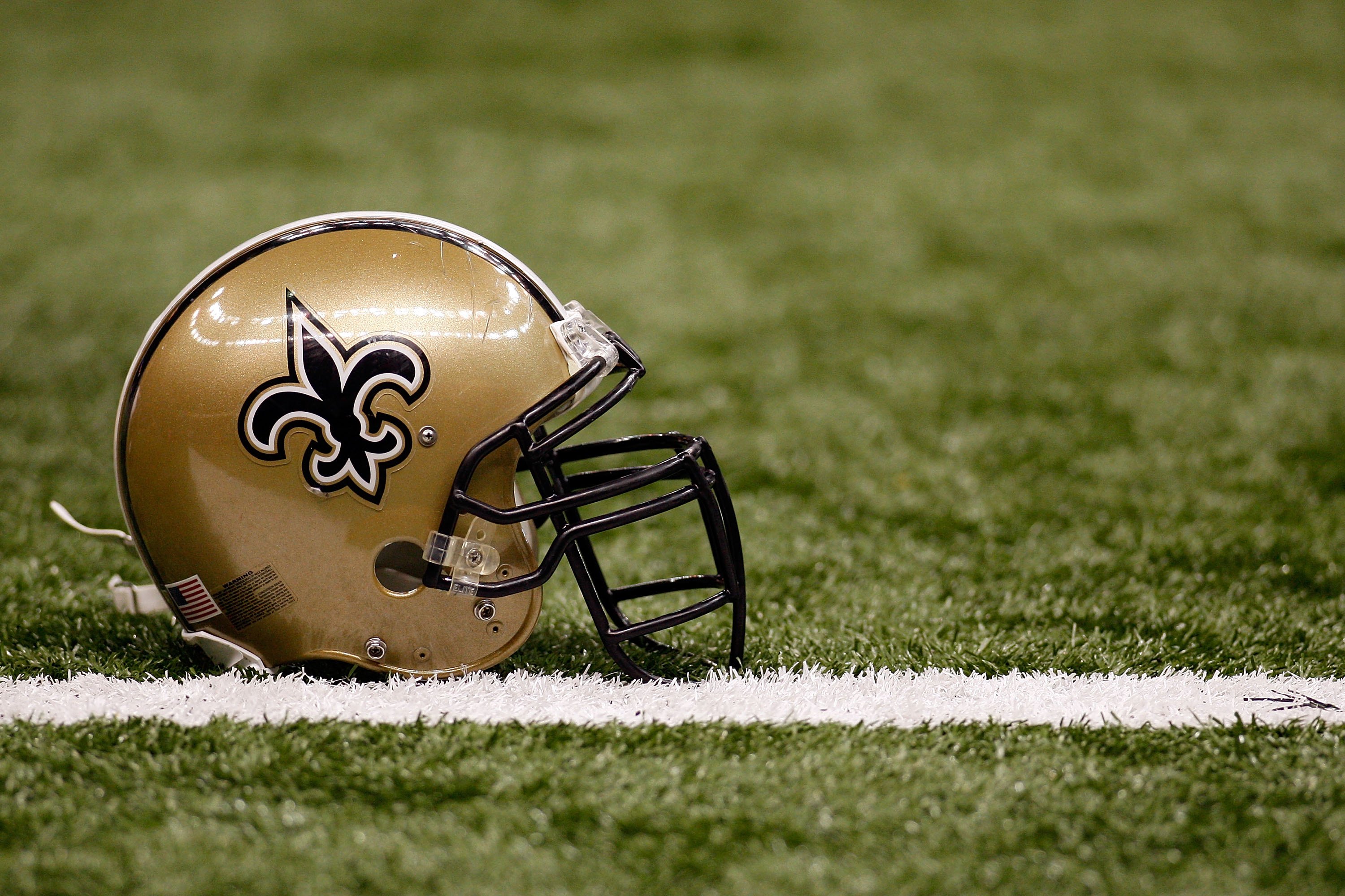 NEW ORLEANS - DECEMBER 19:  A helmet of the New Orleans Saints sits on the ground before the game against the Dallas Cowboys at the Louisiana Superdome on December 19, 2009 in New Orleans, Louisiana.  (Photo by Chris Graythen/Getty Images)