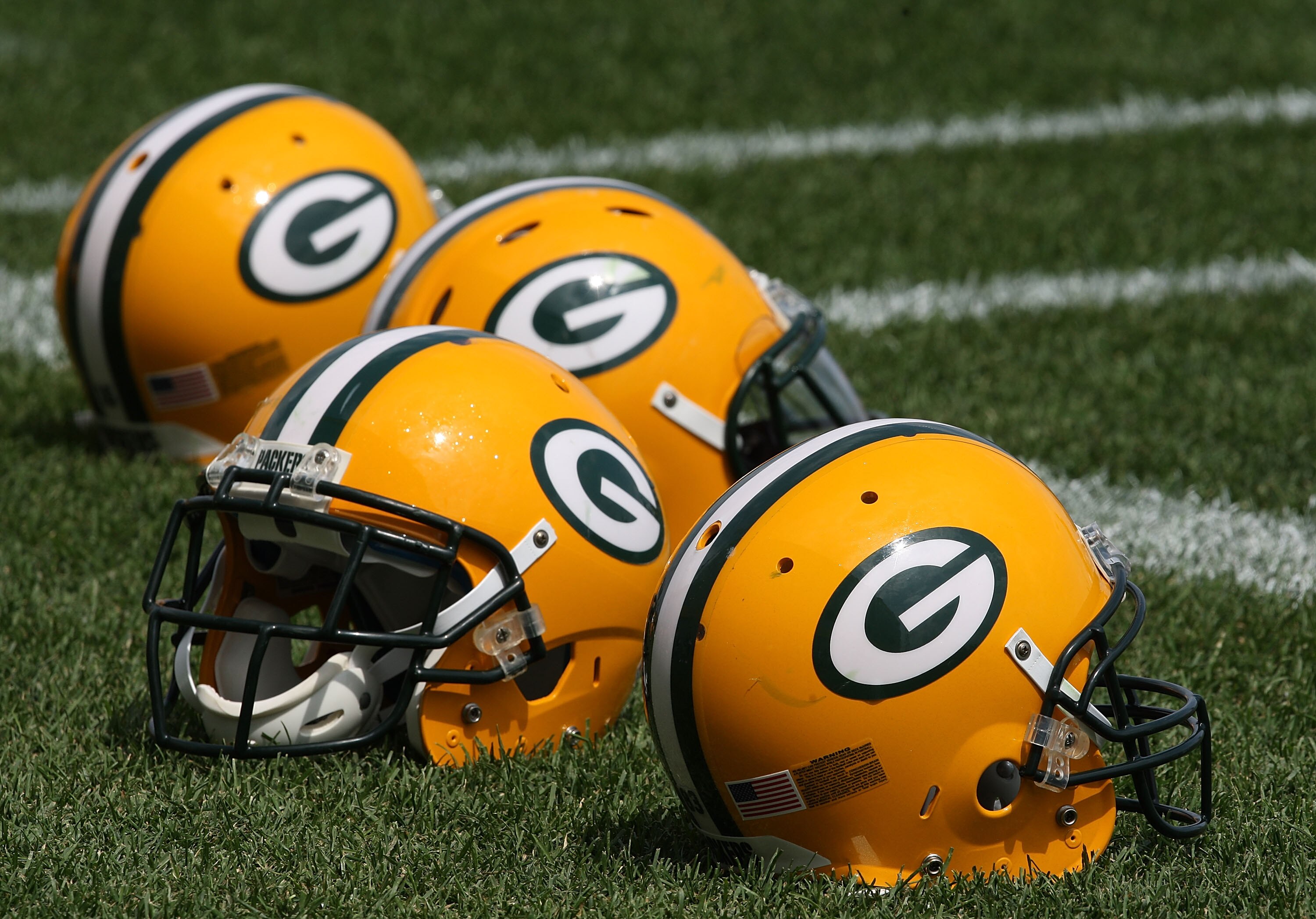 GREEN BAY, WI - AUGUST 03: Helmets sit on the field during the Green Bay Packers practice at summer training camp on August 3, 2009 at the Ray Nitschke Field in Green Bay, Wisconsin. (Photo by Jonathan Daniel/Getty Images)
