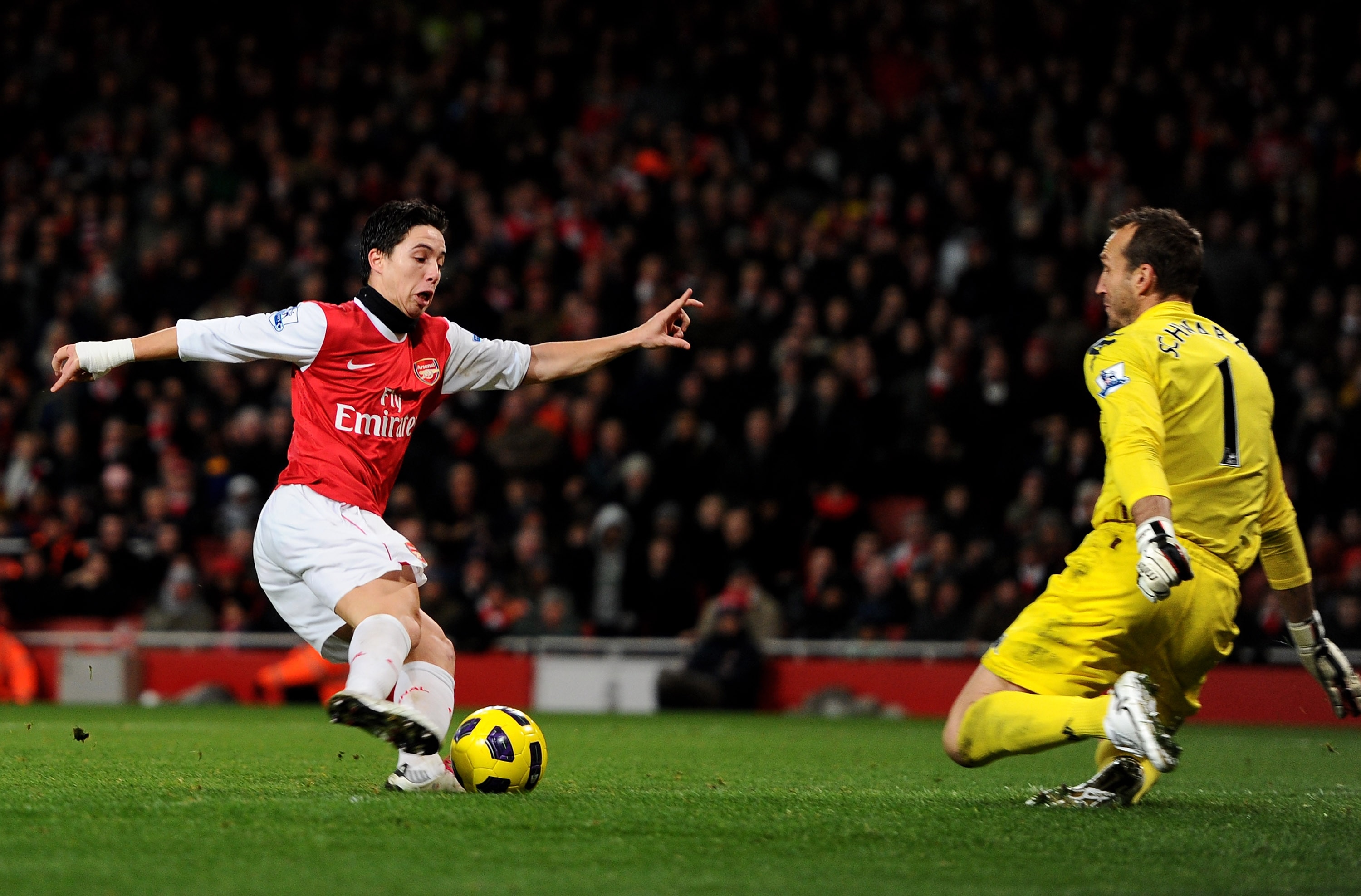 LONDON, ENGLAND - DECEMBER 04: Samir Nasri of Arsenal takes the ball past Fulham goalkeeper Mark Schwarzer to score the winning goal during the Barclays Premier League match between Arsenal and Fulham at the Emirates Stadium on December 4, 2010 in London,